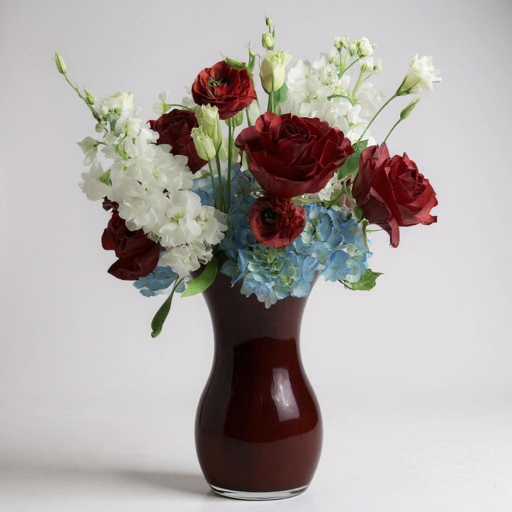 The Patriot - Celebrate America or any day with this red, white, and blue arrangement! Perfect for sending as a thank you gift for a Fourth of July, Memorial Day or The New Year!  Vase Subject to Change