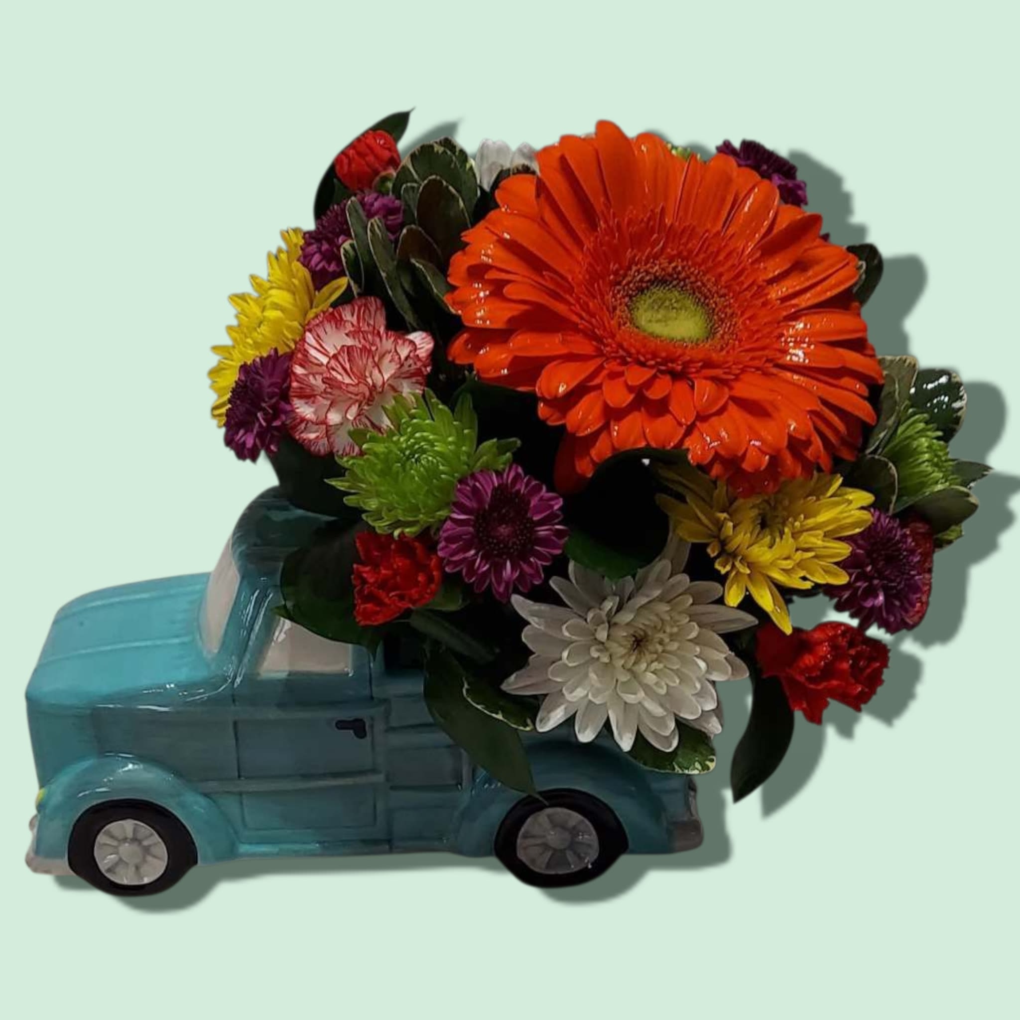 Keep On Truckin' Keep On Truckin' - A whimsical blue pick-up truck with it's bed full of bright blooms is sure to brighten anyone's day. Keep On Truckin' inspires the receiver to keep going, no matter what! The arrangement features Gerbera daisies, cushion mums, daisy mums, button mums, and mini carnations. Colors will vary with availability. Approximate size: 12"L x 9" H.