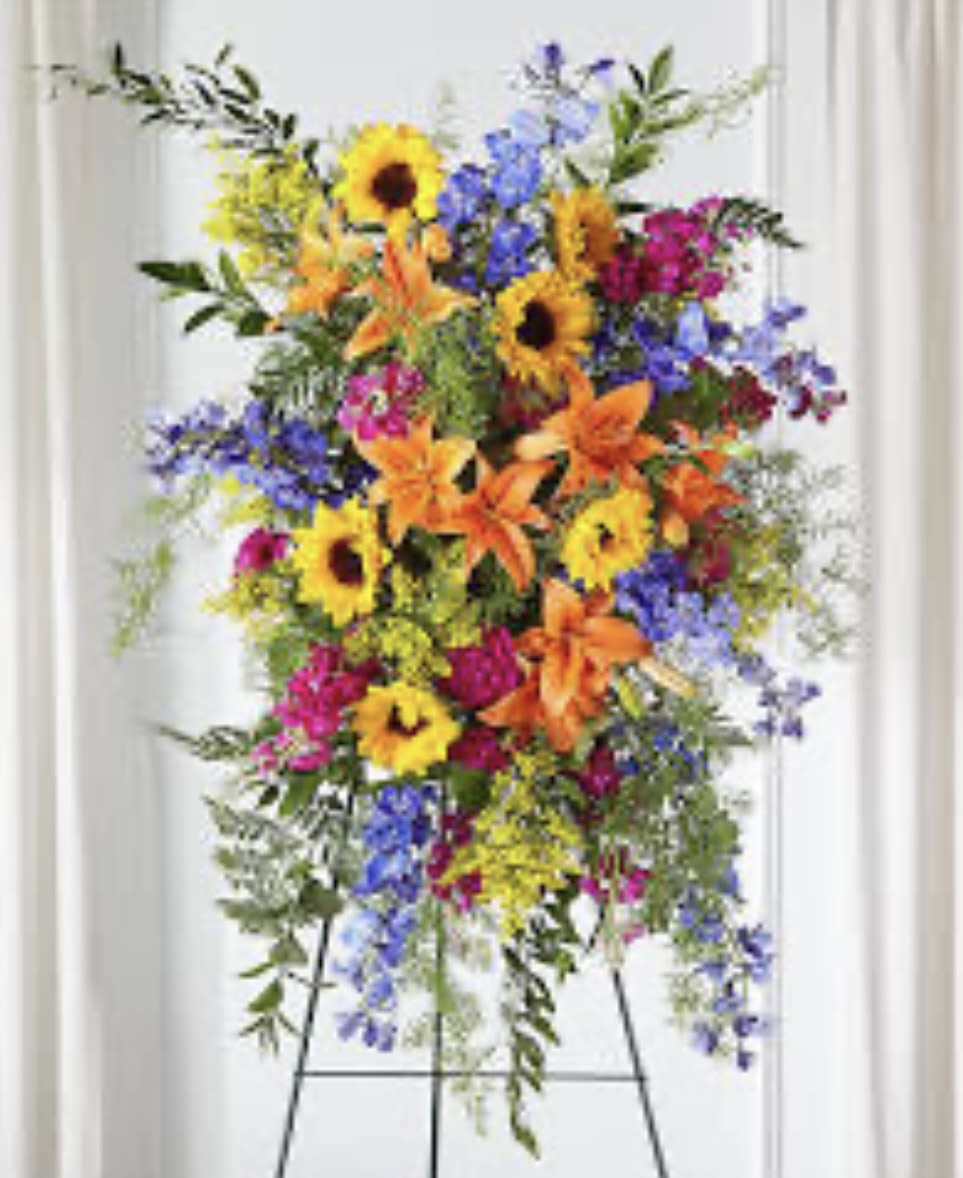 sunflower memories standing spray sunflower memories standing spray - our sunflower memories standing spray is crafted with a mix of fuchsia, blue, hot pink and orange florals to celebrate their radiant life. this vibrant display combines bright shades with stunning texture while sharing thoughtful sentiments and comfort to loved ones.