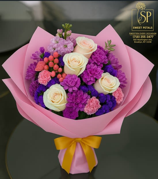 Blush Elegance Blush Elegance - Flowers by SweetPetals – Brooklyn proudly presents Blush Elegance from our Luxury Collection, a bouquet that radiates charm and sophistication. This stunning arrangement by Flowers by SweetPetals – Brooklyn features creamy ivory roses, vivid purple statice, magenta carnations, soft pink spray carnations, and fresh hypericum berries, creating a harmonious blend of soft romance and vibrant color. Wrapped in blush-pink luxury paper and tied with a golden satin ribbon, the Blush Elegance bouquet by Flowers by SweetPetals – Brooklyn is perfect for birthdays, anniversaries, romantic gestures, or simply to brighten someone’s day. Every bloom is hand-selected for freshness and beauty, arranged with expert care to deliver an unforgettable floral experience. With free same-day delivery across Brooklyn, Flowers by SweetPetals – Brooklyn ensures your Blush Elegance bouquet arrives fresh, vibrant, and breathtaking.