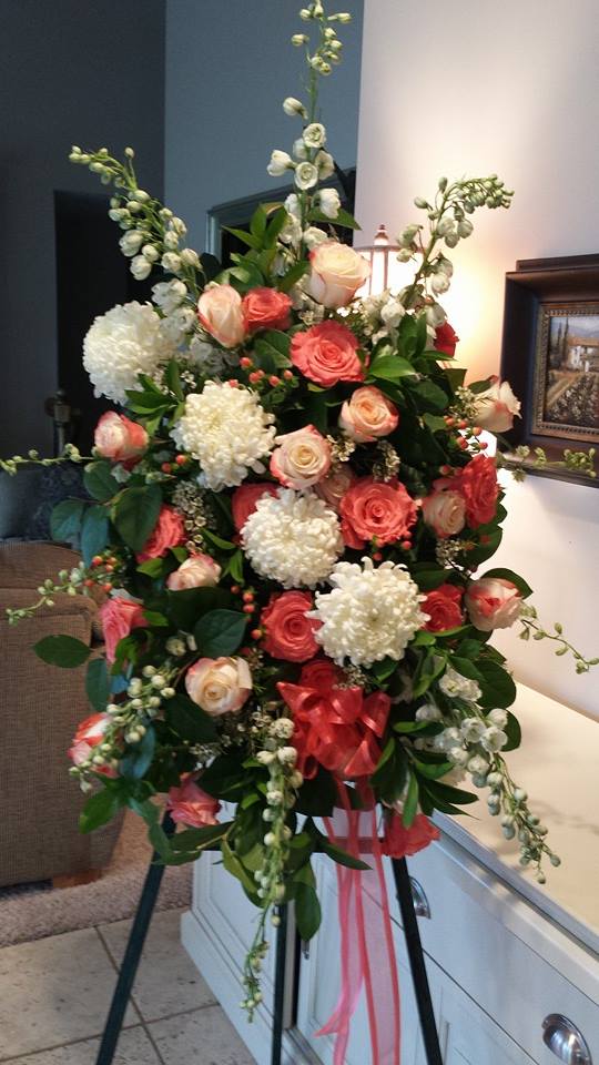 Timeless Blessings Easel Spray by Simply Flowers - A traditional design of white football mums, white hybrid delphinium, bi-color roses, and lush greenery make up this beautiful tribute for the loss of a loved one. 