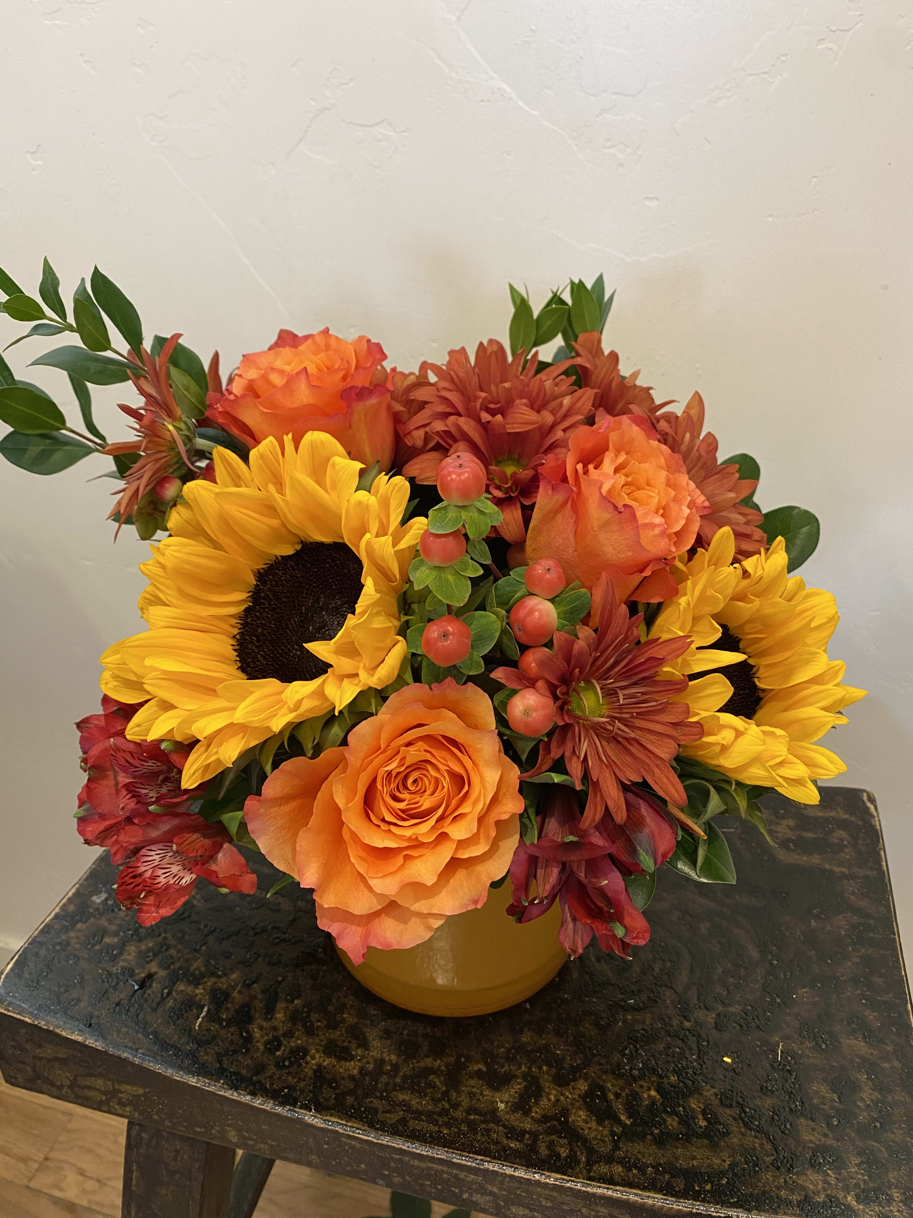 Colors of the Season - A beautiful compact fall bouquet of sunflowers, chrysanthemums, hypericum and roses designed in a colorful heavy glass vessel