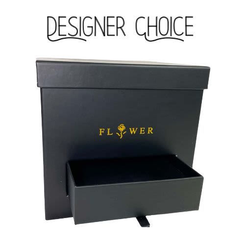 Designer Choice - The Black Box - Indulge in the ultimate expression of elegance with our Designer's Choice arrangement.  A curated selection of the freshest, most exquisite blooms is artfully arranged and presented in a sleek, black gift box.  Hidden within, a secret drawer reveals a delightful assortment of fine chocolates, creating a truly luxurious and unforgettable gift experience.  This is more than just flowers; it's a statement of refined taste.  *please let us know if you have a floral color preference 