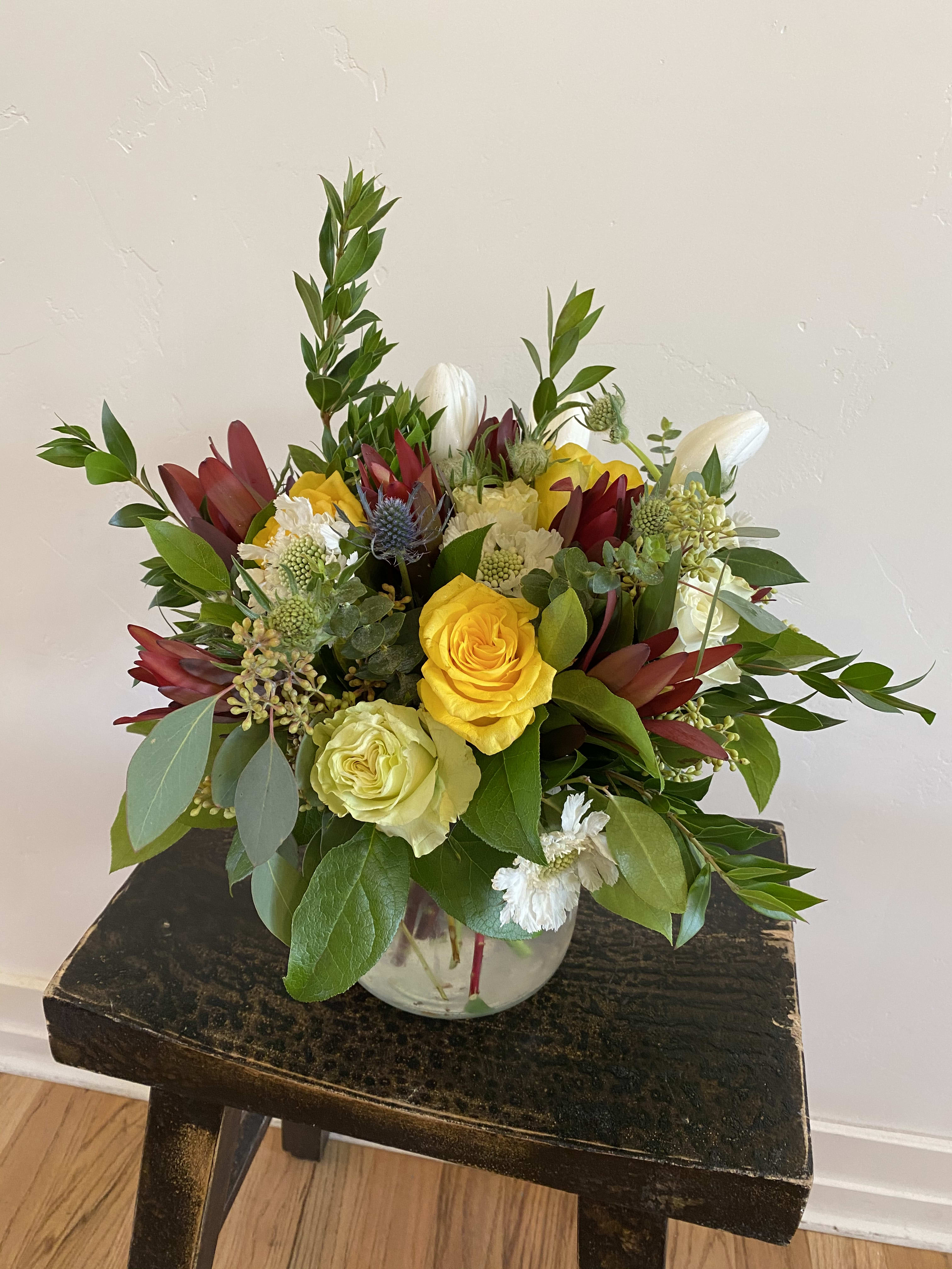 Simply Organic with a Twist Simply Organic with a Twist - Our Simply Organic design with a pop of color! Fresh, crisp tulips and roses arranged among beautiful seasonal foliage with pops of texture make this arrangement outstanding.