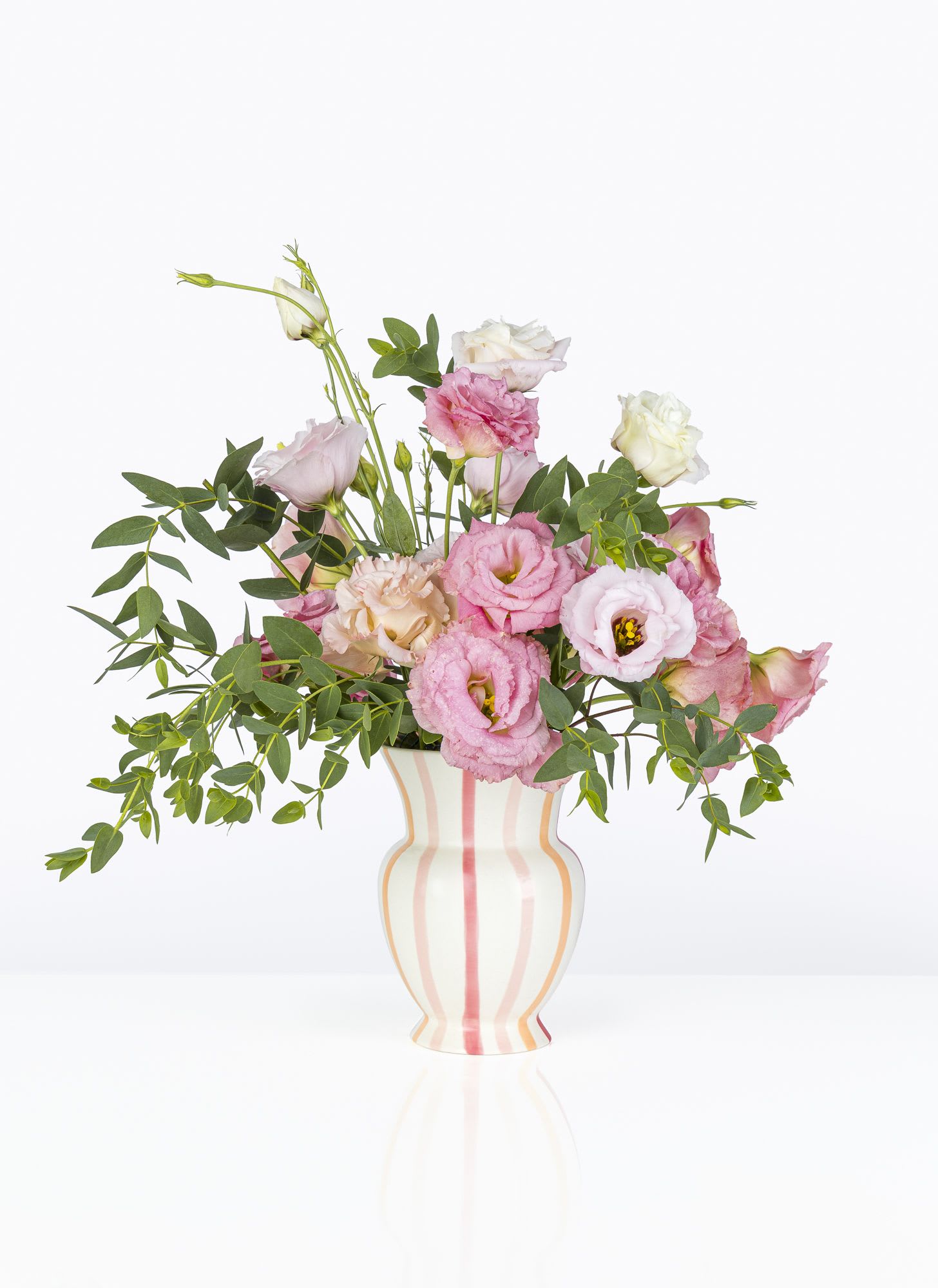 High Summer - Full arrangement filled with local lisianthus and eucalyptus in a ceramic striped vase. 