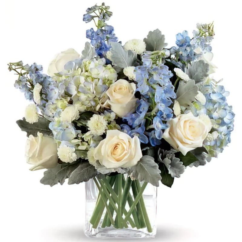 The Faithful Guardian - The Faithful Guardian is handcrafted with White roses, White Button Mums, Blue Delphinium and Blue Hydrangeas.