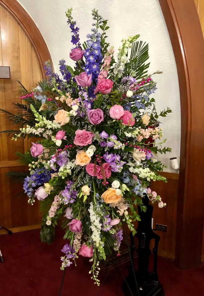 Grandma's Garden Standing Spray Grandma's Garden Standing Spray - A fresh mix of the season, snapdragons, roses, stock, and other locally frown flowers make this a beautiful tribute to your loved one. The picture gives an example of the overall theme. The designer will arrange your order with the seasons freshest flowers keeping with the overall theme shown. NOT available for same day delivery. 48 hour notice required.