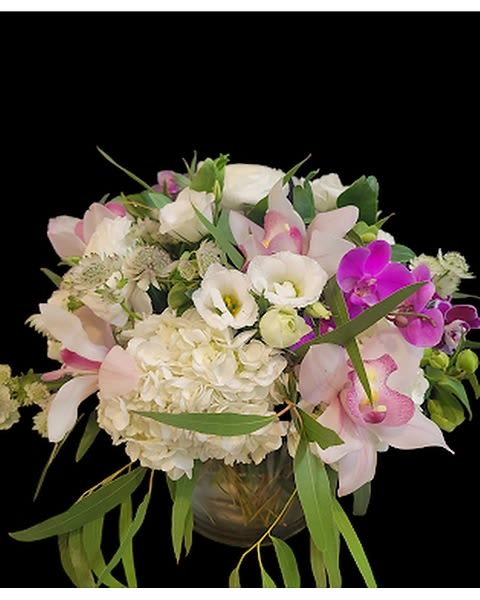 Elegant Blush Round - Peonies, Orchids, Hydrangea with greenery in a Clear Vase Flowers that are high quality, fresh, and beautiful. While we may seasonally need to substitute for flower variety also we may sometimes need to use a different vase or different greens for sub material.