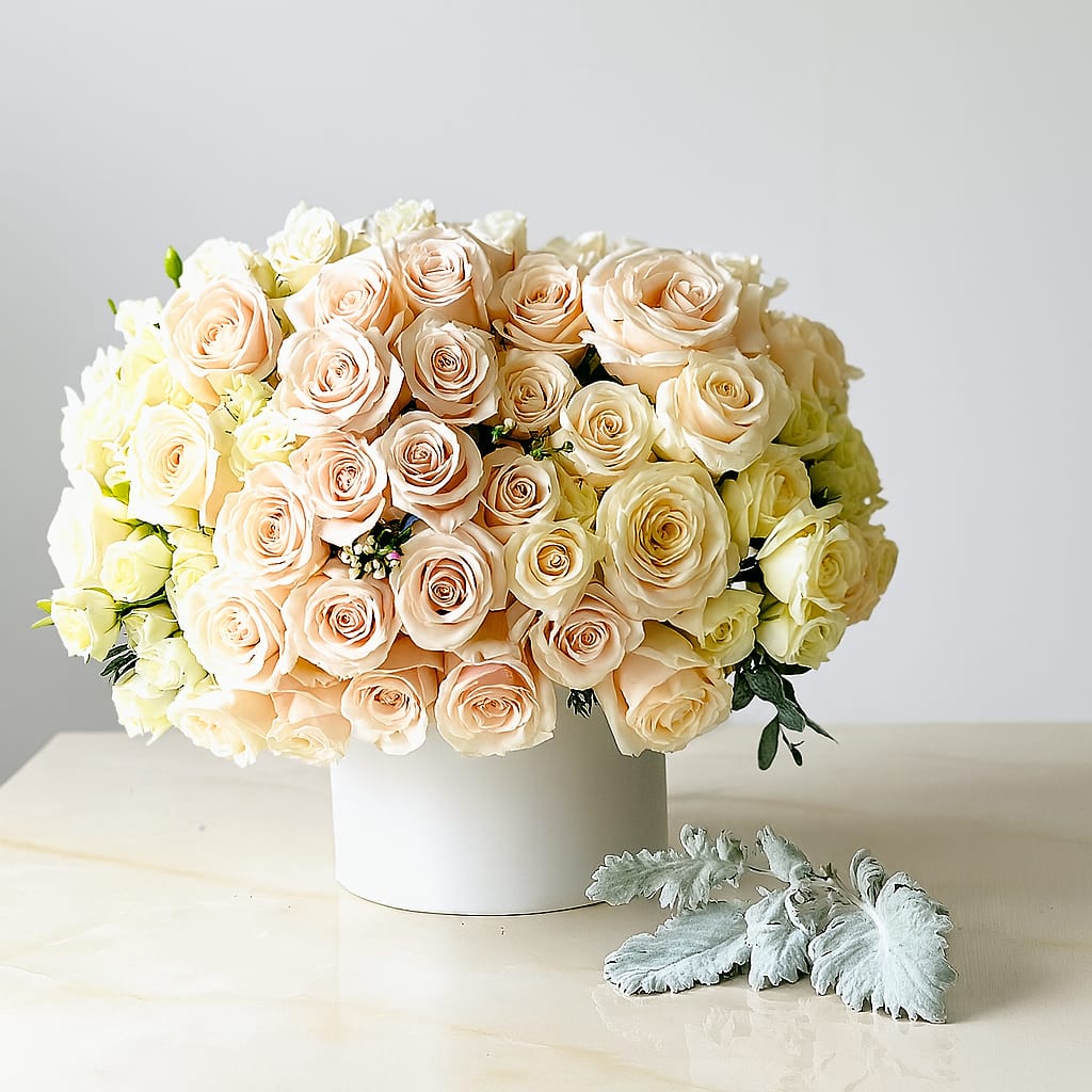 Champagne Cream Elegance Champagne Cream Elegance - A luxurious arrangement of hand-picked champagne and cream roses, elegantly styled in a modern white hat box. Perfect for weddings, anniversaries, or upscale gifting, this design blends timeless beauty with refined charm — crafted to leave a lasting impression.