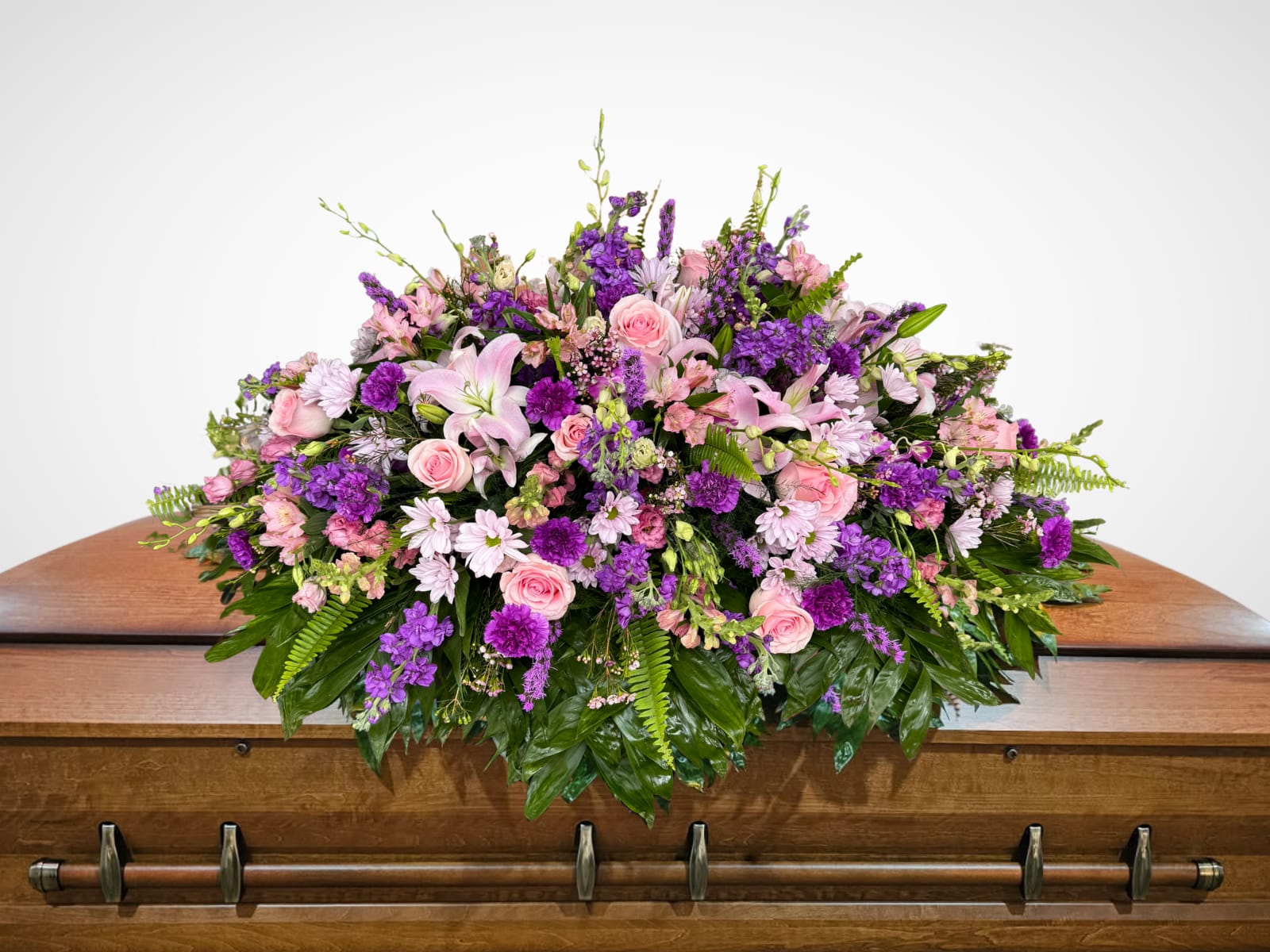 A Gentle Goodbye A Gentle Goodbye - This elegant casket spray features soft, graceful shades of purple and pink, offering a serene and heartfelt tribute. The gentle colors create a peaceful expression of love and remembrance, honoring the memory of someone dearly missed.