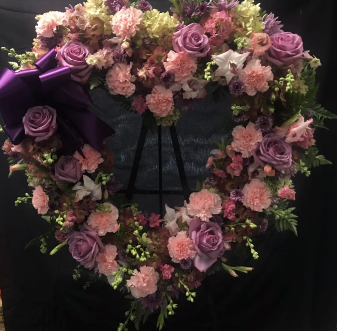 Purple Garden Open Heart Purple Garden Open Heart - Beautiful shades of purple flowers arranged on an open heart wreath.