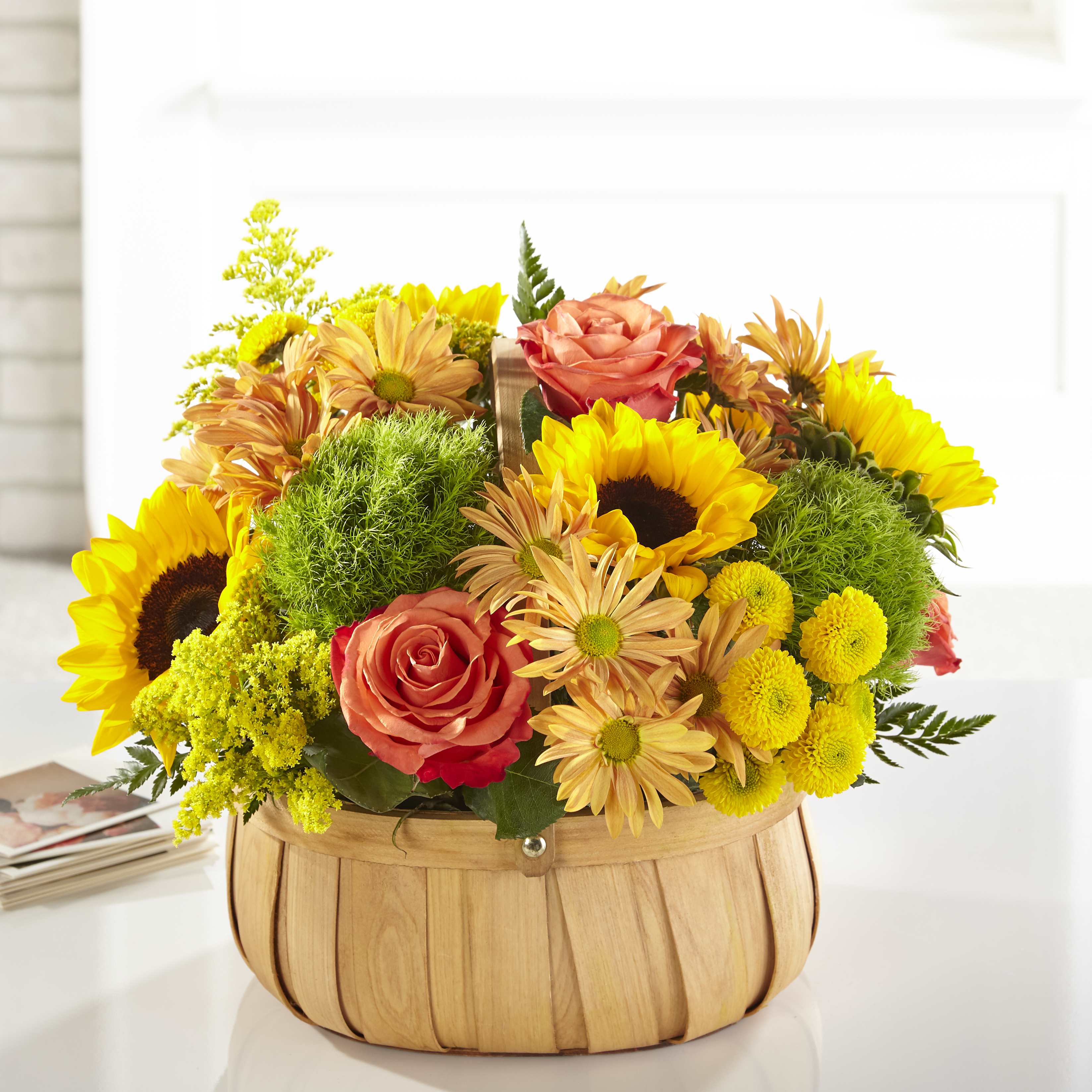 Harvest Sunflower Basket - Rustic, natural beauty and vibrant shades fill this arrangement. Our Harvest Sunflower Basket is the perfect mix of bold sunflowers, roses and dianthus in a natural woven basket.