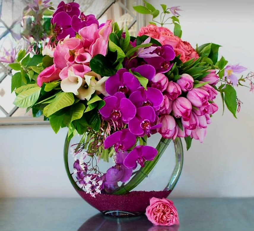 Under the Seas by Pretty in Petals  - A lush, deep-sea arrangement of sea-color lilies, calla lilies, and orchids. Perfect for a nautical lover, or for someone who likes to escape the everyday hustle and bustle and dive into a tranquil sea of their own.