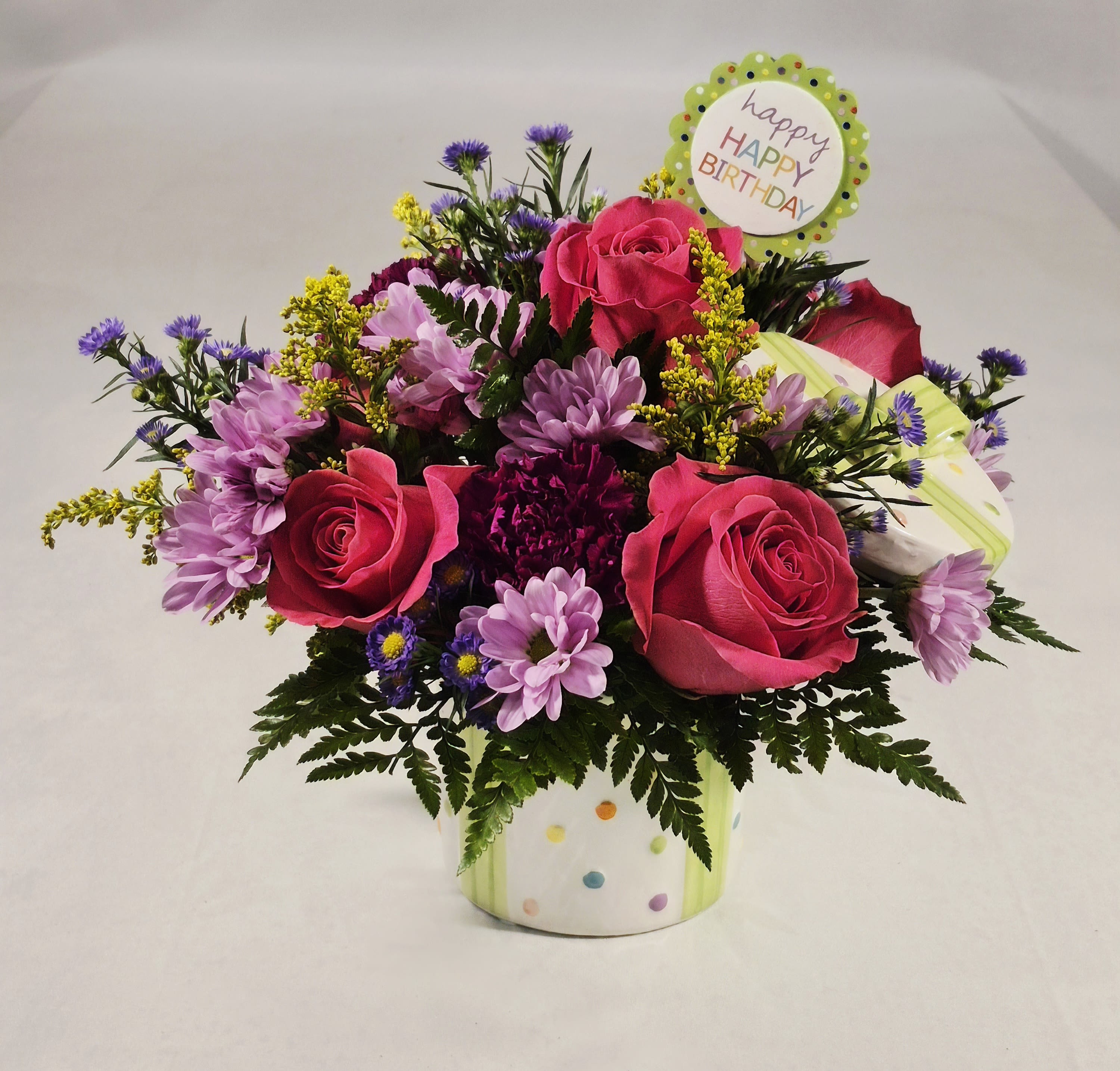 Happy Birthday Present Bouquet - Send a birthday surprise that’s bursting with color and celebration. Arrives in a keepsake ceramic container designed to look like a wrapped gift featuring the phrase, “Happy Happy Birthday” on a decorative pick in a food safe ceramic container and lid.   Measures 5&quot;H x 4.5&quot;W 