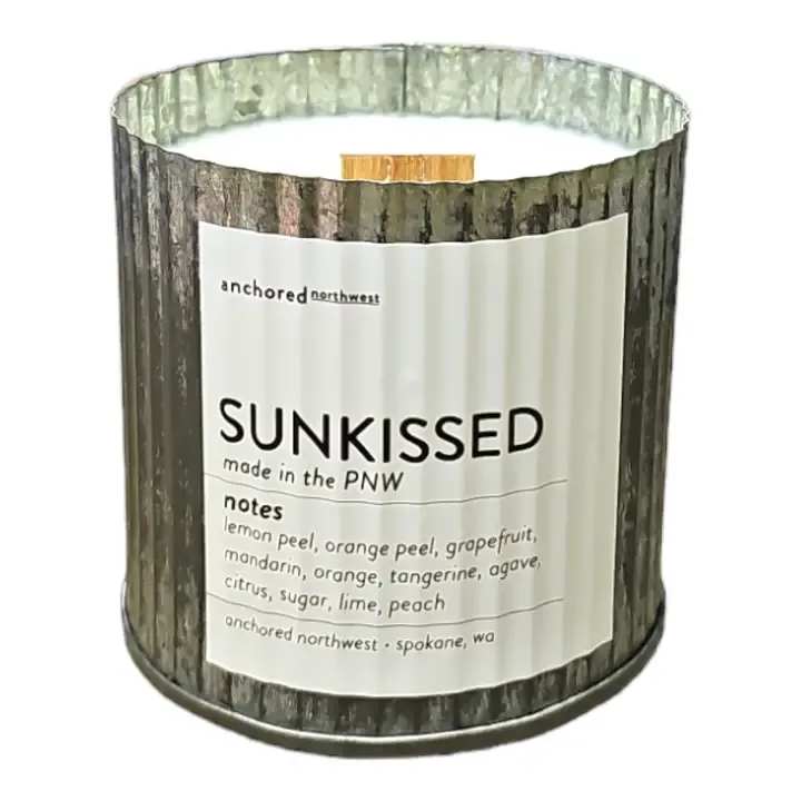 Anchored Northwest - Sunkissed Candle - About this product  Sunkissed Wood Wick Rustic Farmhouse Soy Candle (60 hour burn)  Notes: Lemon Peel, Orange Peel, Grapefruit, Mandarin, Orange, Tangerine, Agave, Citrus, Sugar, Lime, Peach  Our #1 selling candle container.  *Testers are not available for this container due their high popularity.  Ingredients: 10 ounces poured in a Rustic Vintage container Untreated Cedar Wood Wick 100% Soy Wax grown in the US. Fragrance and Essential Oil Blend Dye and Phthalate free  Anchored Northwest soy wax candles are a great gift for any season, be it Spring, Summer, Fall or Winter. A perfect addition to any home decor.  Our wood wick, triple scented, 100% soy wax candles are hand poured in Spokane, WA. We use real ingredients in our candles - fragrance oils infused with essential oils, 100% American-grown soy wax, and untreated cedar wood wicks.