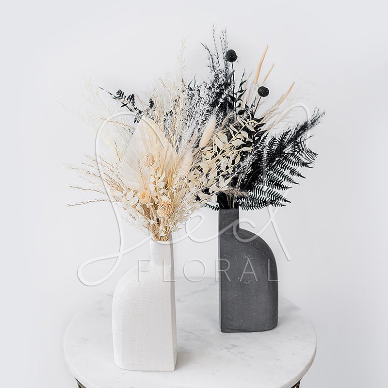 Yin Yang  - Yin Yang. They Say Opposites Attract.  Two Tone Set of Karis Vases with preserved dried florals in shades of whites, creams, blacks and grey.  Vase Dimensions: 4.0 x 2.5 x 8.75