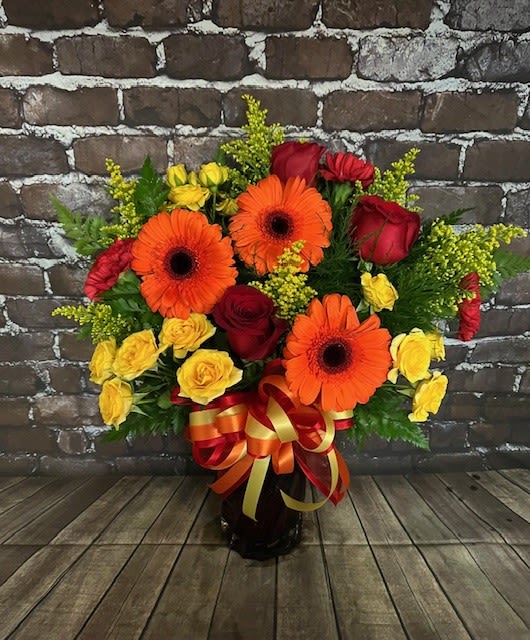 Eternal Flame Eternal Flame - A bright and beautiful arrangement fills a deep red swirled glass vase. Approx. 16" W x 20" H