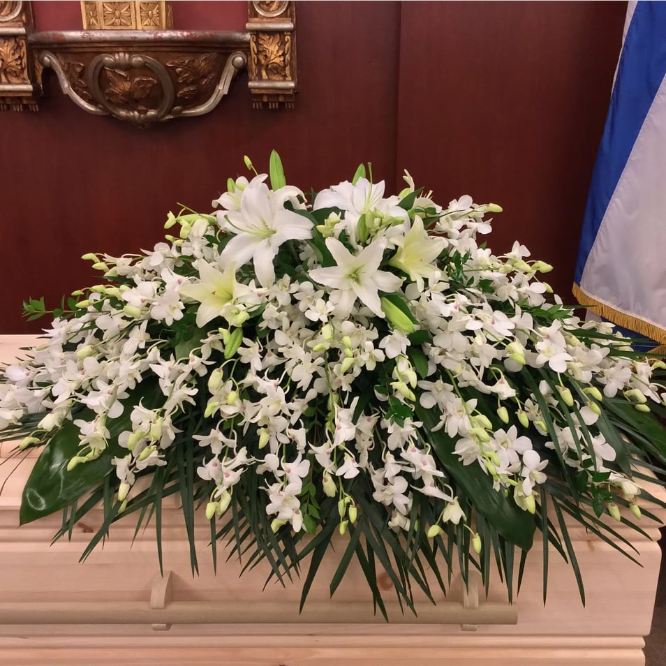Orchids and Lilies Casket Spray Orchids and Lilies Casket Spray - A classic tribute of 50 white dendrobium orchids accented with white oriental and asiatic lilies and roses. Please note this item IS NOT AVAILABLE for same day delivery.