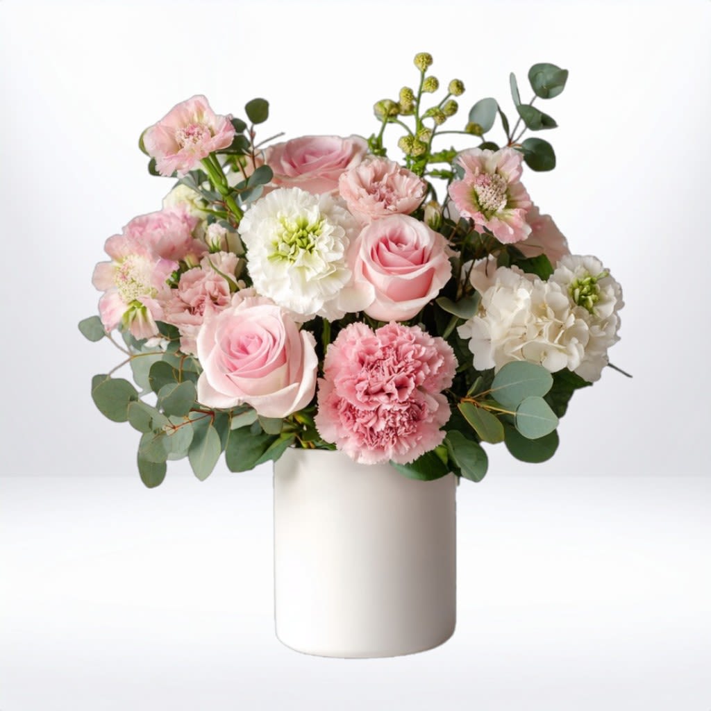 Pink Charm Bouquet Pink Charm Bouquet - Radiating charm and cheer, the Pink Charm Bouquet is a delightful floral arrangement designed to brighten any space. Featuring a vibrant hot pink gerbera daisy, soft pink roses, blush chrysanthemums, white stock, scabiosa, and accents of waxflower and greenery, this bouquet is presented in a sleek matte white vase for a fresh modern touch. Perfect for birthday flowers, congratulations, thank you gifts, or just because. Now available for same-day flower delivery in Galveston, South Houston, Texas City, La Marque, and surrounding areas. Substitution Policy: Every Pink Charm Bouquet is thoughtfully handcrafted with fresh seasonal blooms. In the event a specific flower variety (such as scabiosa or stock) is unavailable, we will substitute with blooms of comparable value, color, and style to maintain the arrangement’s look and feel. Vase style may vary slightly based on availability.