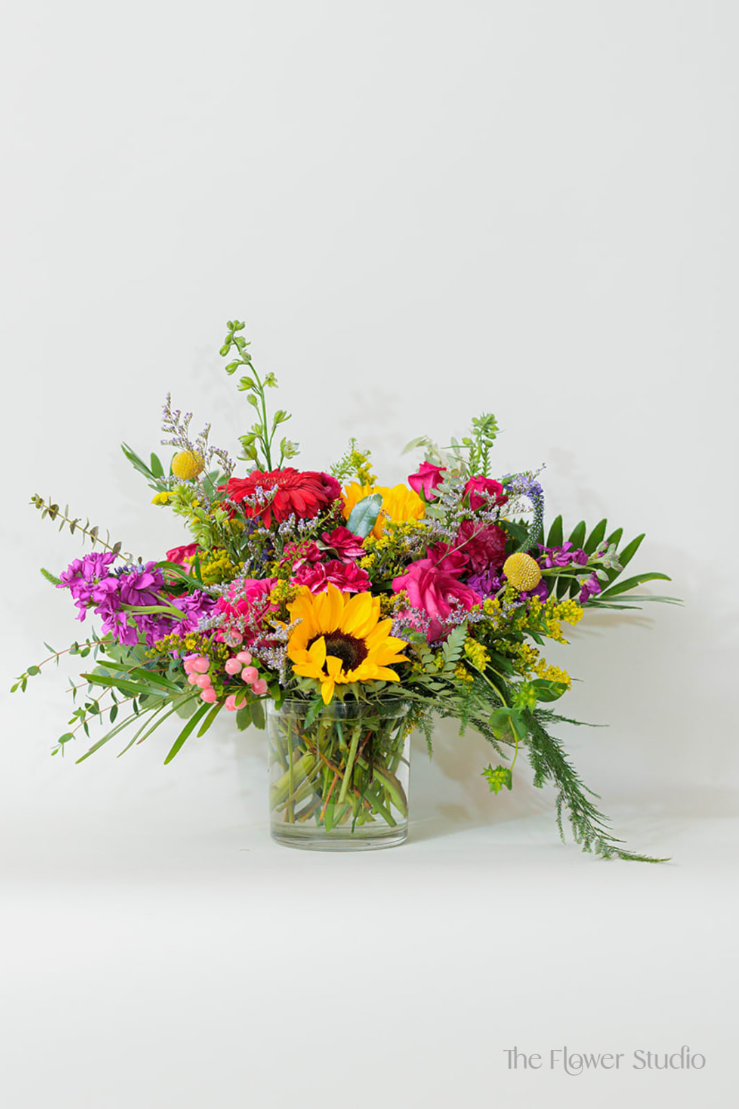 Sorbet Sorbet - Sorbet: " A frozen dessert made primarily of fruit juice or fruit purée, sugar, and water" A perfect name for our arrangement! Colorful flowers - similar to summer fruit hues, make this one a customer favorite. Measurements: about 17" W x 14" H Our floral artists hand-design each arrangement, so flower and container styles may vary based on local and seasonal availability. As a result, we are unable to guarantee specific florals, colors, or vessels—but we always ensure the same level of beauty and value in every piece.