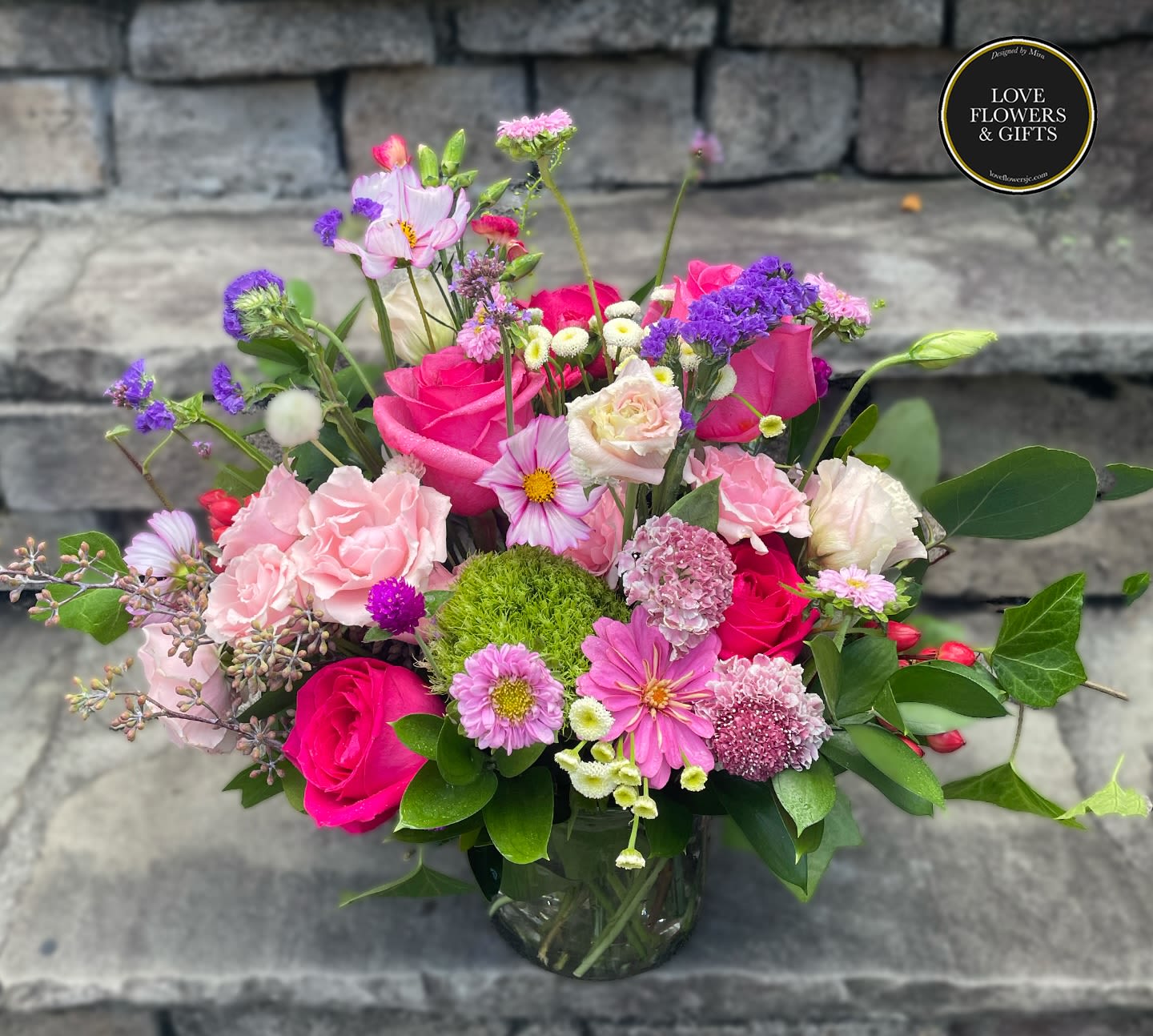 Star Dance Star Dance - Beautifully lush seasonal arrangement designed in glass vase made with pinks and hints of violets and creams.