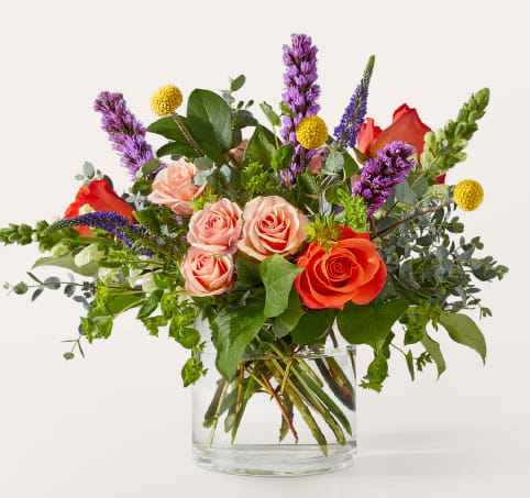 The Standout Bouquet The Standout Bouquet - The Standout Bouquet commands attention with bold Orange Roses, striking Purple Larkspur, and architectural Snapdragons, accented by Veronica and rustic Eucalyptus. Presented in a modern glass vase, this dramatic arrangement is perfect for achievements, anniversaries, or when you need to make an unforgettable impression. Approximate Size: 12"H x 13"W. Order now for fresh flower delivery!