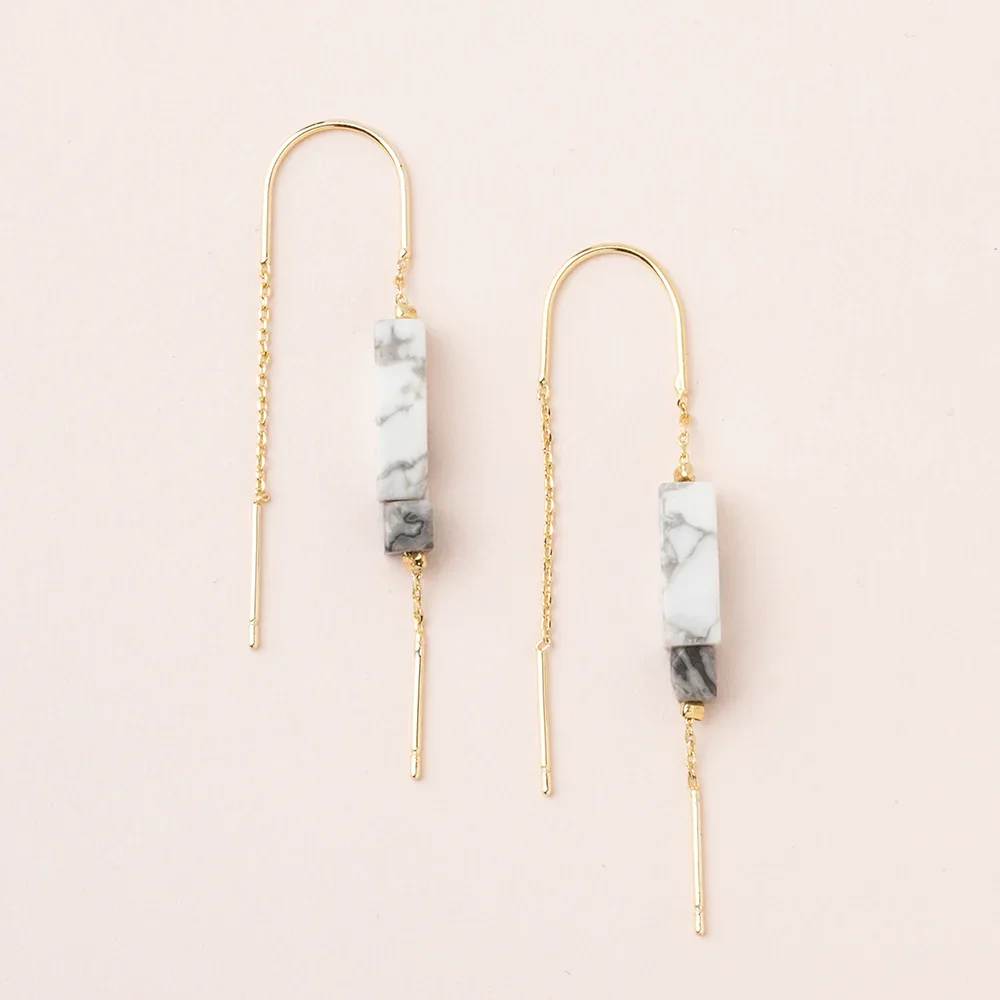 Threader Earring w/ Rectangle Stone - Howlite/Black/Gold - Our new line of minimalistic charm to adorn your ears. Lightweight with the perfect amount of color and shape. Whether you want to look polished or down-to-earth is up to you and your mood.- Materials: 2.25'' drop. Semi precious rectangle stones 1/2'' and 3/16''. 14K Gold dipped chain and wire. Nickel and Cadmium free.- Earrings come on embossed leather card with stone meaning on back.Howlite : Stone of harmony ET003