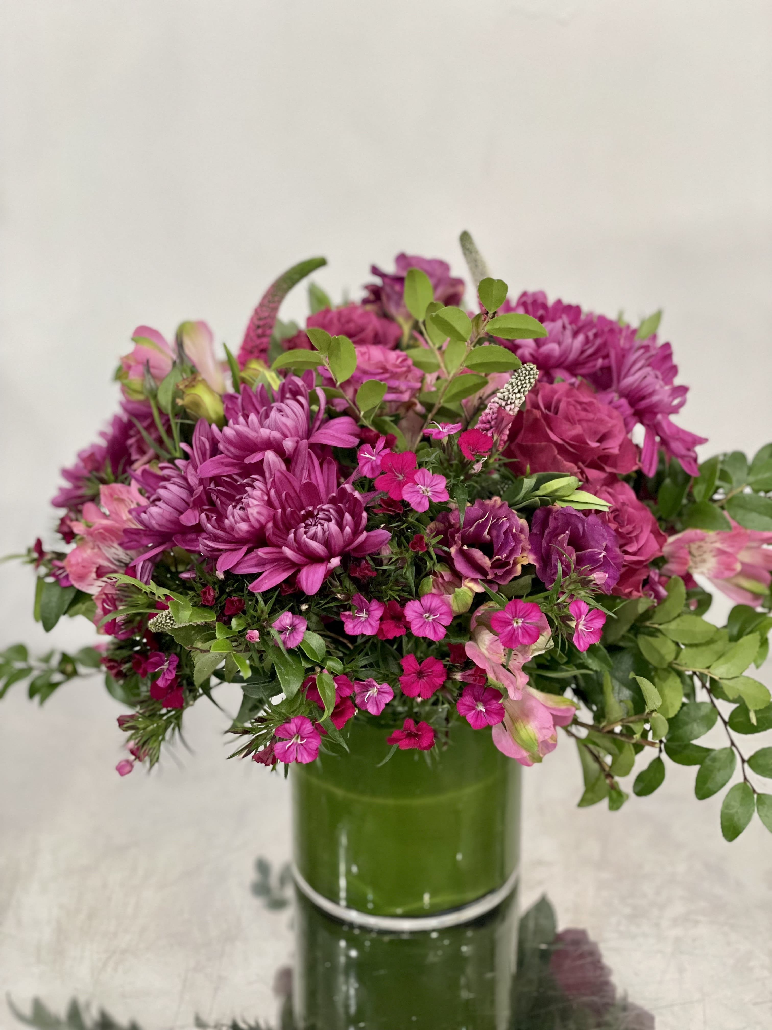 Thank you Berry much  - Designers choice in monochromatic berry tones for the person who loves compact textured flowers.  Designers choice in pinks with greens. We will choose the flowers, you choose the size. This picture is representation of the color palette. While a lot of the flowers will be sourced, some may need to be exchanged with comparable or higher quality flowers.   Standard: Side table sized Deluxe : Dinner table sized Premium : Entryway or coffee table sized  