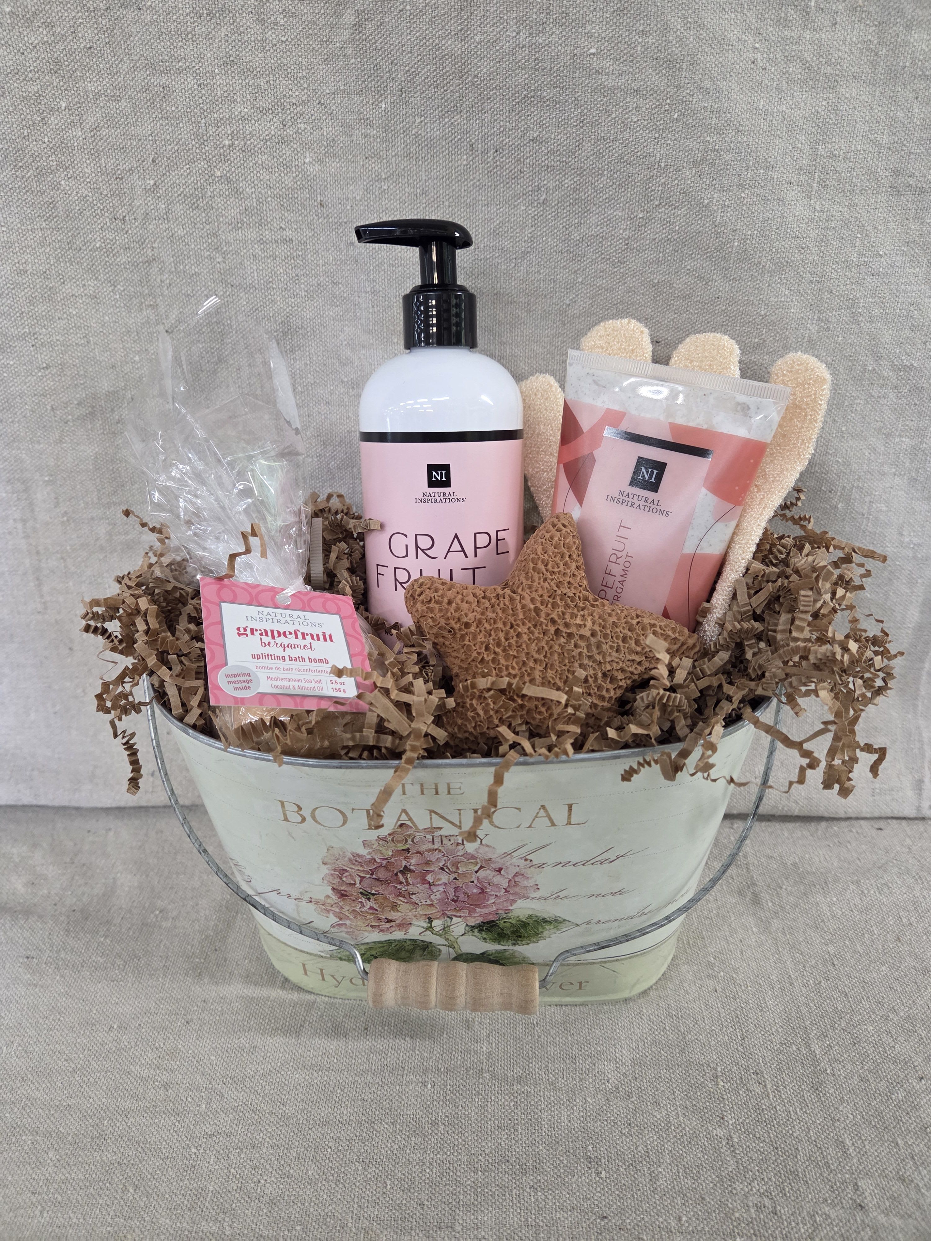 FM Spa Basket - Grapefruit - Our spa basket includes a variety of bath and body products in soothing scents, with additional bath items packaged in a decorative container.