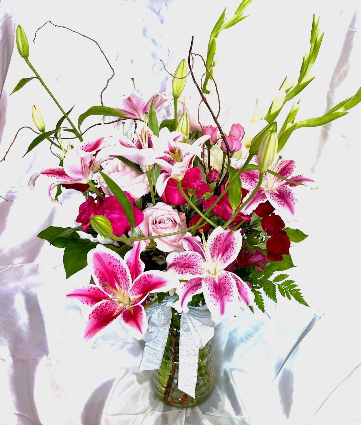 Love is Splendor Love is Splendor - Stunningly beautiful arrangement! Send to someone you love today! Made of stargazer lilies, roses, mums, spray roses, greens and curly willow. Truly a work of floral art!
