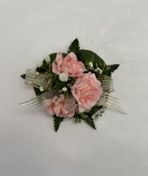 3 MINI CARNATIONS CORSAGE 3 MINI CARNATIONS CORSAGE - LOVELY CORSAGE WITH 3 MINI CARNATIONS (RED, WHITE, OR LIGHT PINK), WITH GREENS AND BABIES BREATH, YOUR CHOICE OF RIBBON. INCLUDES COMPLIMENTARY STANDARD WRISTLET.