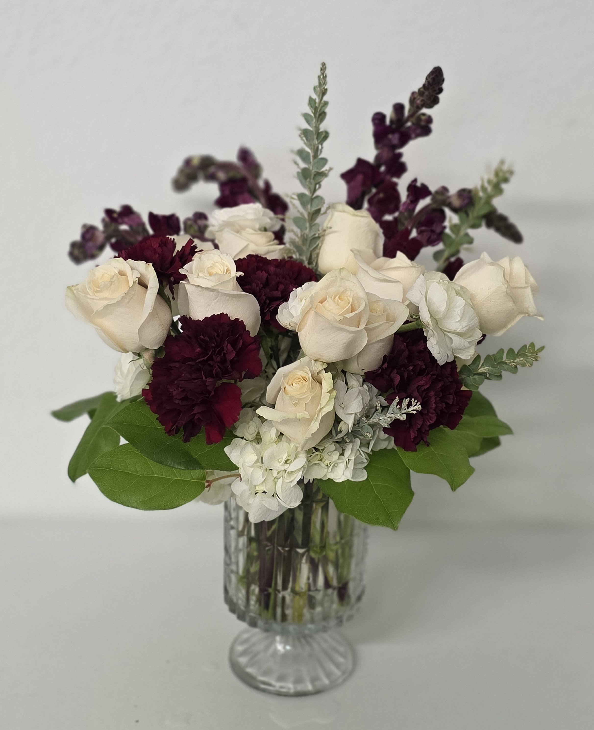 Burgundy Beauty - The Burgundy Beauty is a rich design with burgundy snap dragons, white roses and gorgeous deep burgundy carnations.  It's wonderful for honoring a lost love one or just saying I love you.
