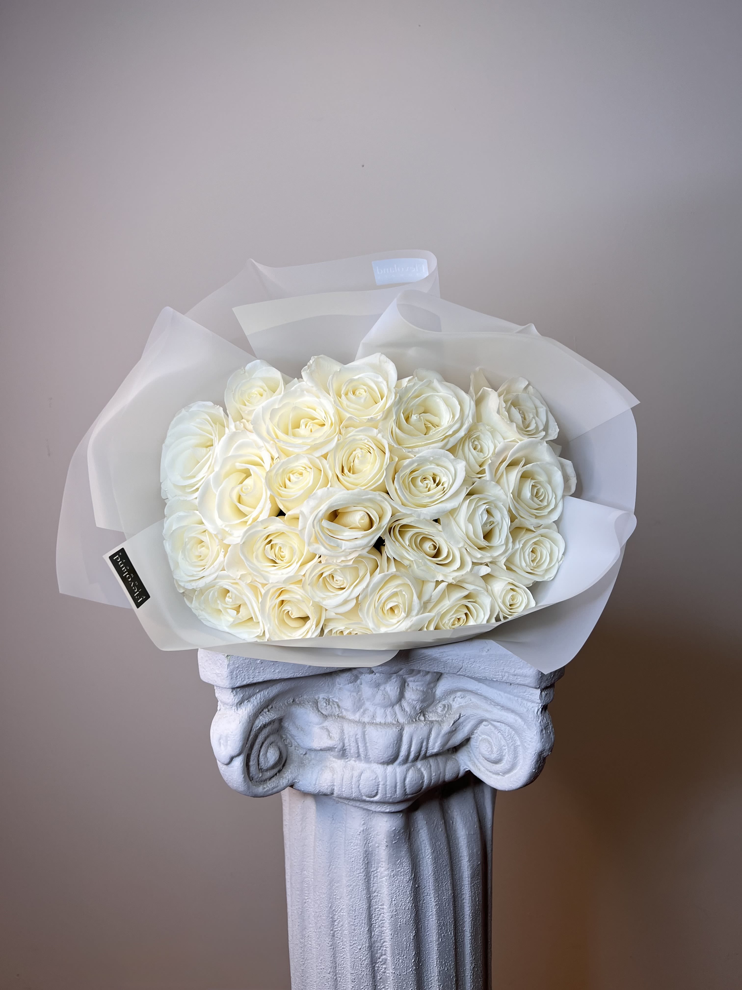 Absolute White - A bouquet of pristine white roses, embodying elegance and purity. Wrapped in sheer paper that enhances their timeless beauty, each petal whispers serenity, gratitude, and sincere love. Perfect for moments that deserve nothing less than distinction.