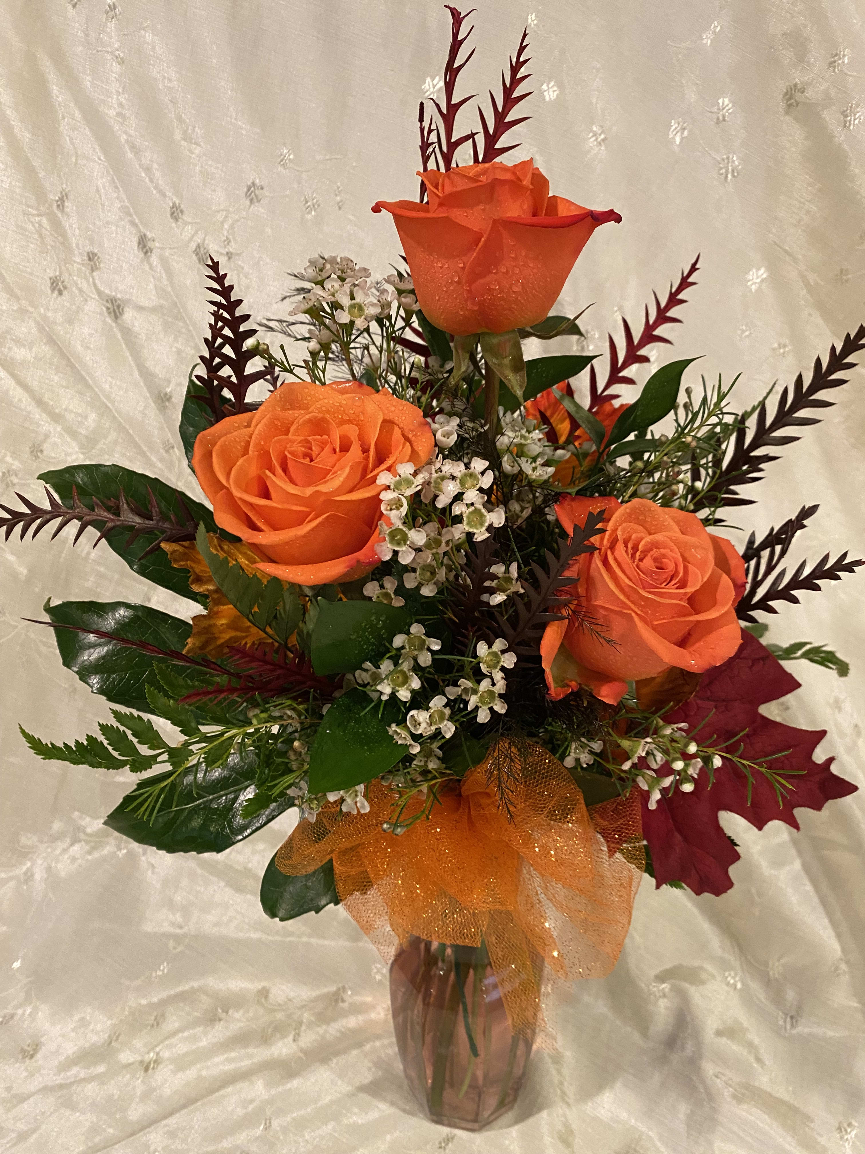 Falling in Love - These 3 orange roses will help you to fall in love with fall again and again.  Shades of the orange roses may vary.