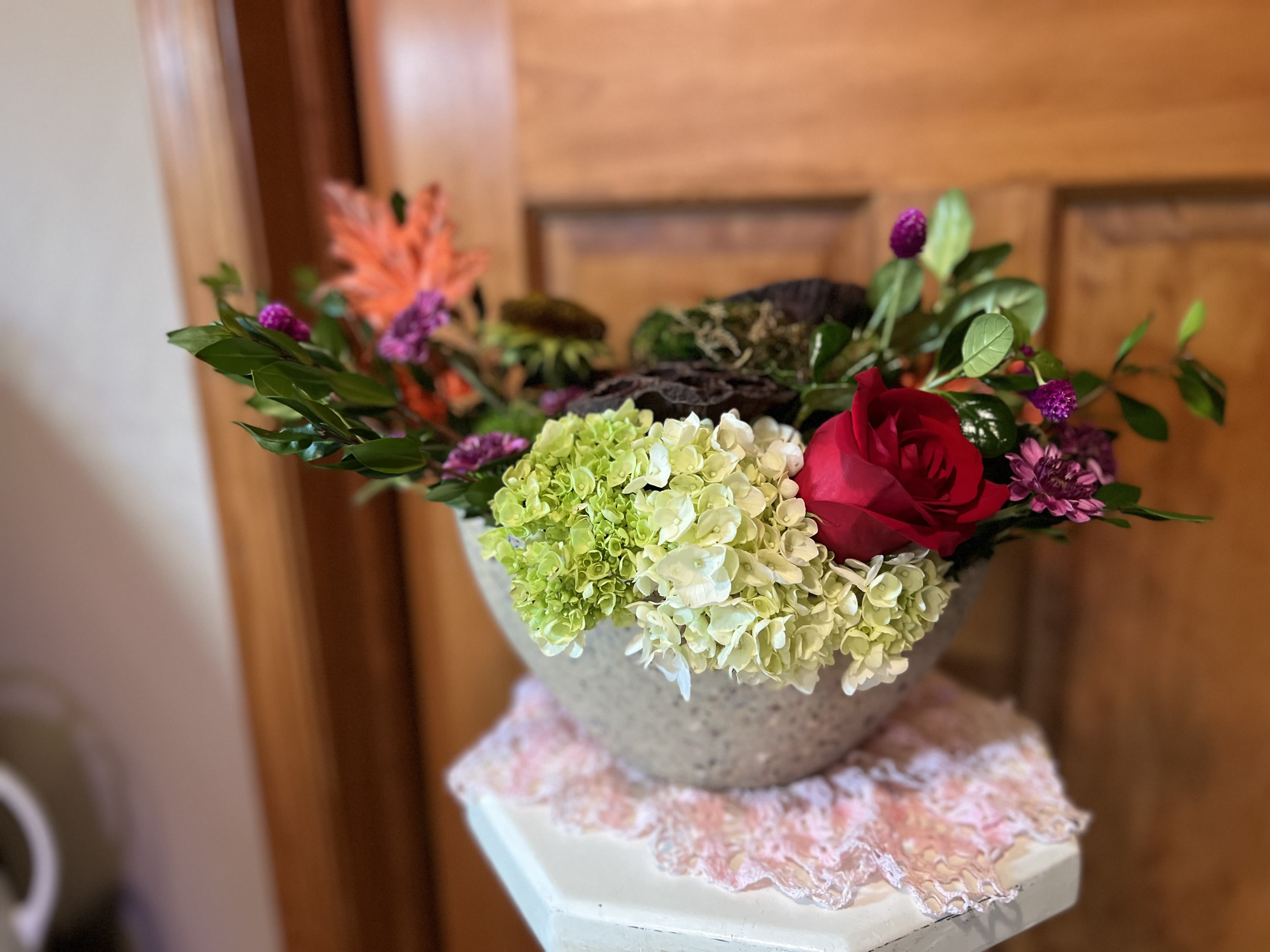 Fall Nights - Welcome to Fall. With this wonderful, colorful fall design of flowers. Dancing with hydrangeas, a single rose, dianthus, a sunflower devoid of petals and chrysanthemum flowers. A few dried pods, silk accents and sheet moss round out the design. All nestled into a ECOessential container that can be reused or composted as it is made from agricultural harvest byproducts including straw, bamboo skin, corn and coffee husks. Natural colors provide the look of stone 