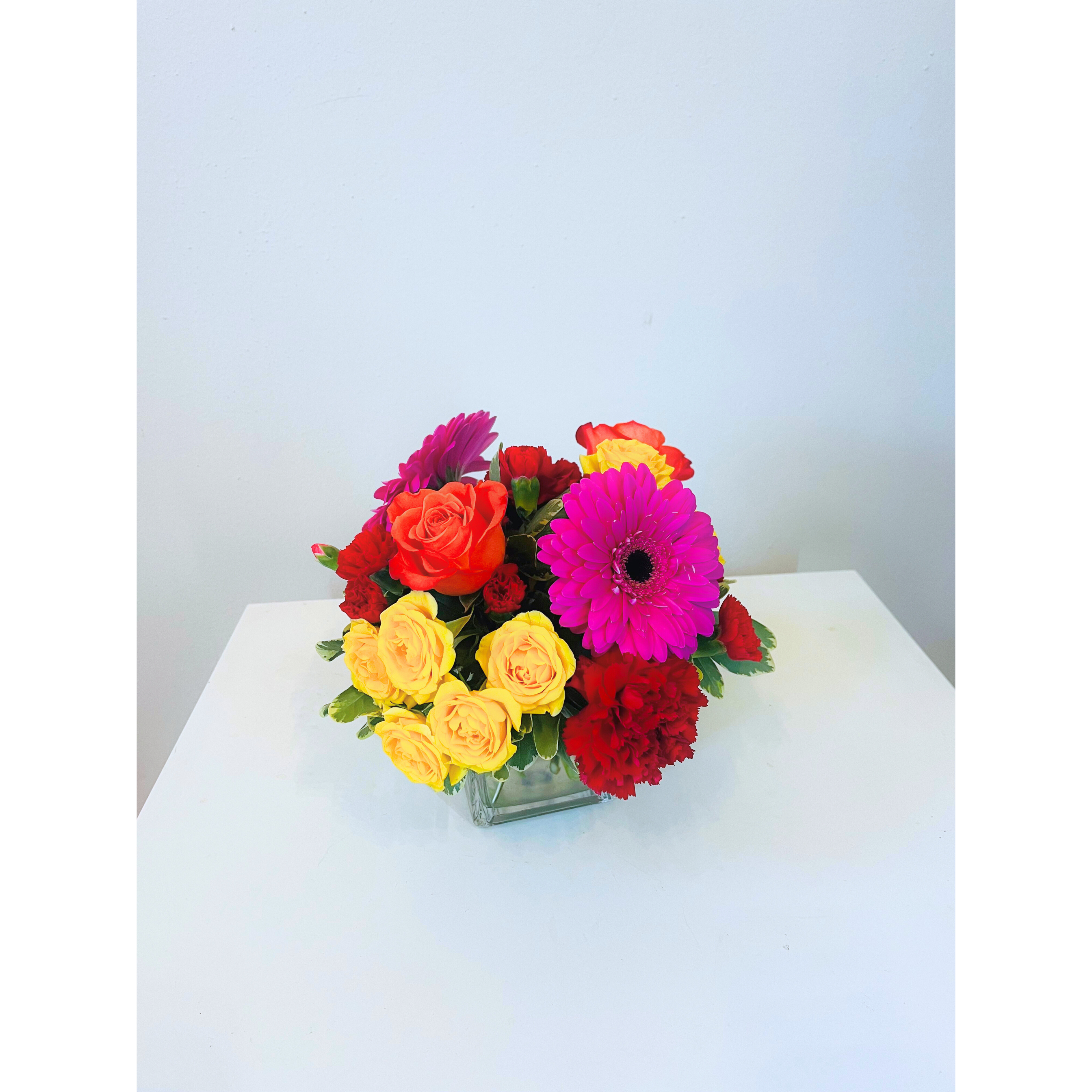 Little Mix Vibrance - A playful fusion of vivid hues and striking textures, Little Mix Vibrance bursts with energy and personality. Featuring a bold blend blooms. This arrangement channels the spirit of confidence, color, and creative flair. Designed for those who love to stand out, it’s the perfect floral statement for any celebration or mood-lifting moment.