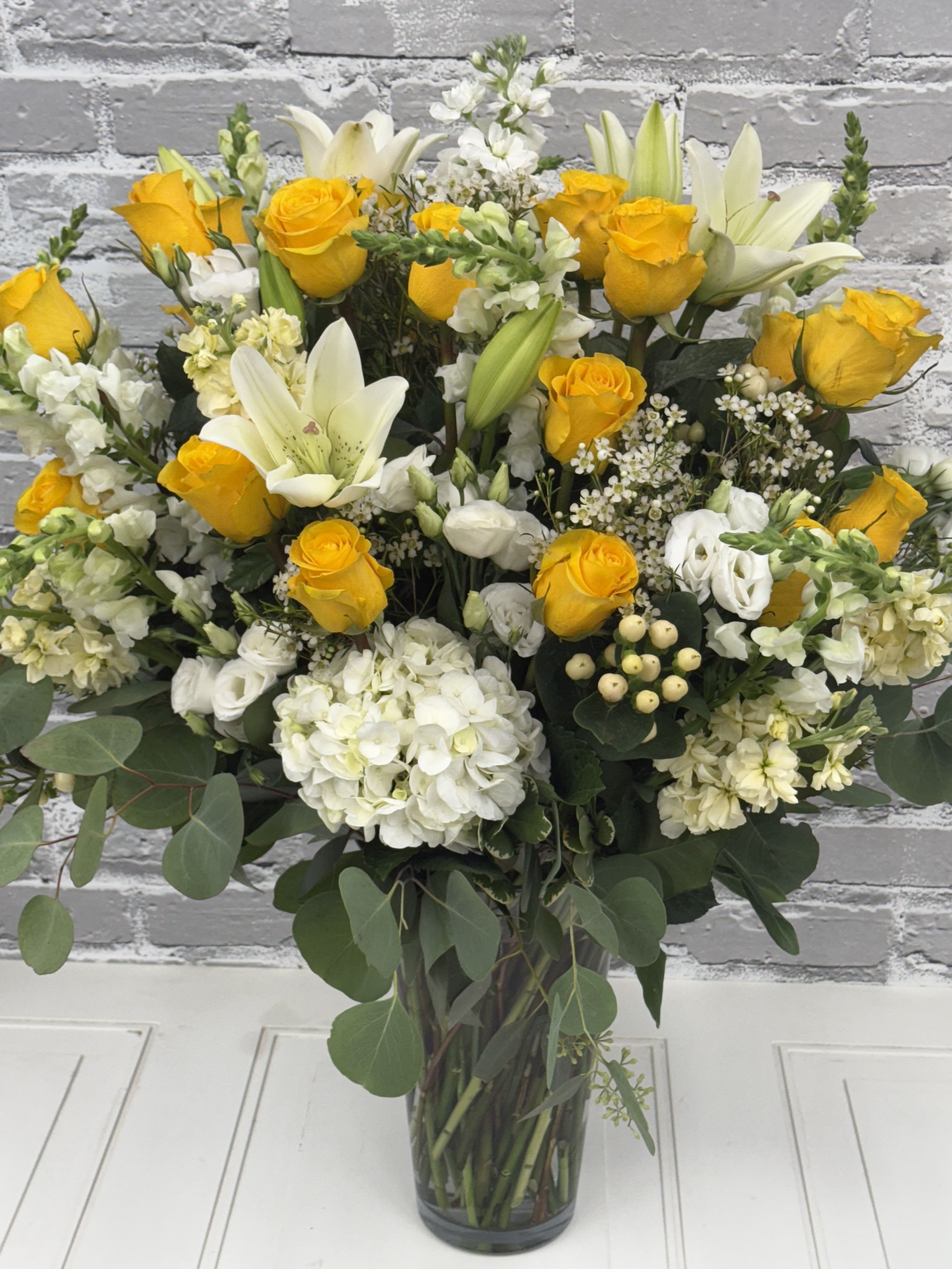 Yellow/White Large Vase - Stunning and Large. This showstopper features beautiful premium flowers in the yellow and white shades of flowers. Flowers may vary due to availability.  *** This can be designed in a different color palette upon request! ***