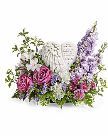 Remembering Love Bouquet - A heartfelt tribute to a cherished life, Teleflora's Remembering Love Bouquet surrounds Teleflora's Heaven's Heart Keepsake with an elegant mix of soothing blooms. Featuring a delicate angel wing design and a touching inscription, this beautiful keepsake offers comfort, love, and a lasting reminder of precious memories. Remembering Love Bouquet features lavender roses, lavender alstroemeria, white carnations, lavender stock, purple button spray chrysanthemums, purple sinuata statice, leatherleaf fern, and pitta negra. Arranged with Teleflora's Heaven's Heart Keepsake, this elegant tribute brings comfort and remembrance. Approximately 17 1/2&quot; W x 14&quot; H