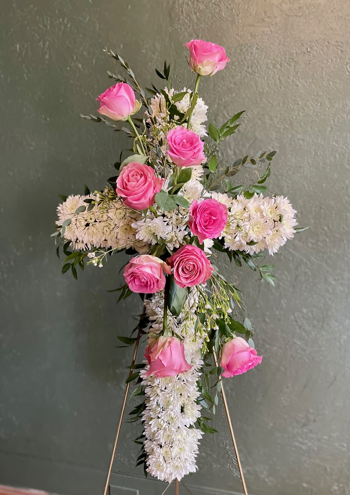Pink Roses Sympathy Cross Pink Roses Sympathy Cross - A beautiful sympathy cross with white cushions and pink roses. Rose color can be customized. Available colors: white, pink, and red. Add color choice during Checkout under "Special Instructions". Dimensions: approximately 30"
