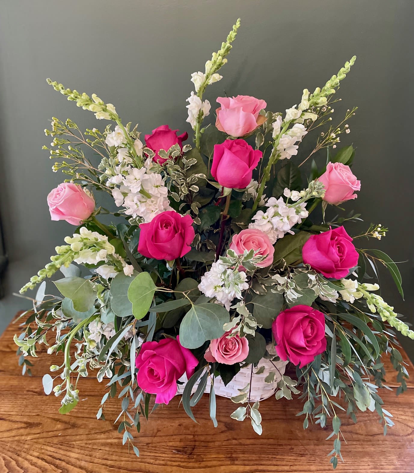 Pink Roses Sympathy Basket Pink Roses Sympathy Basket - A basket full of blooms and color with roses, stock, and greenery. Colors can be customized. Available colors: red, white, and pink. Add color preference during check out under "Special Instructions". Dimensions: approximately 24" H x 22" W.
