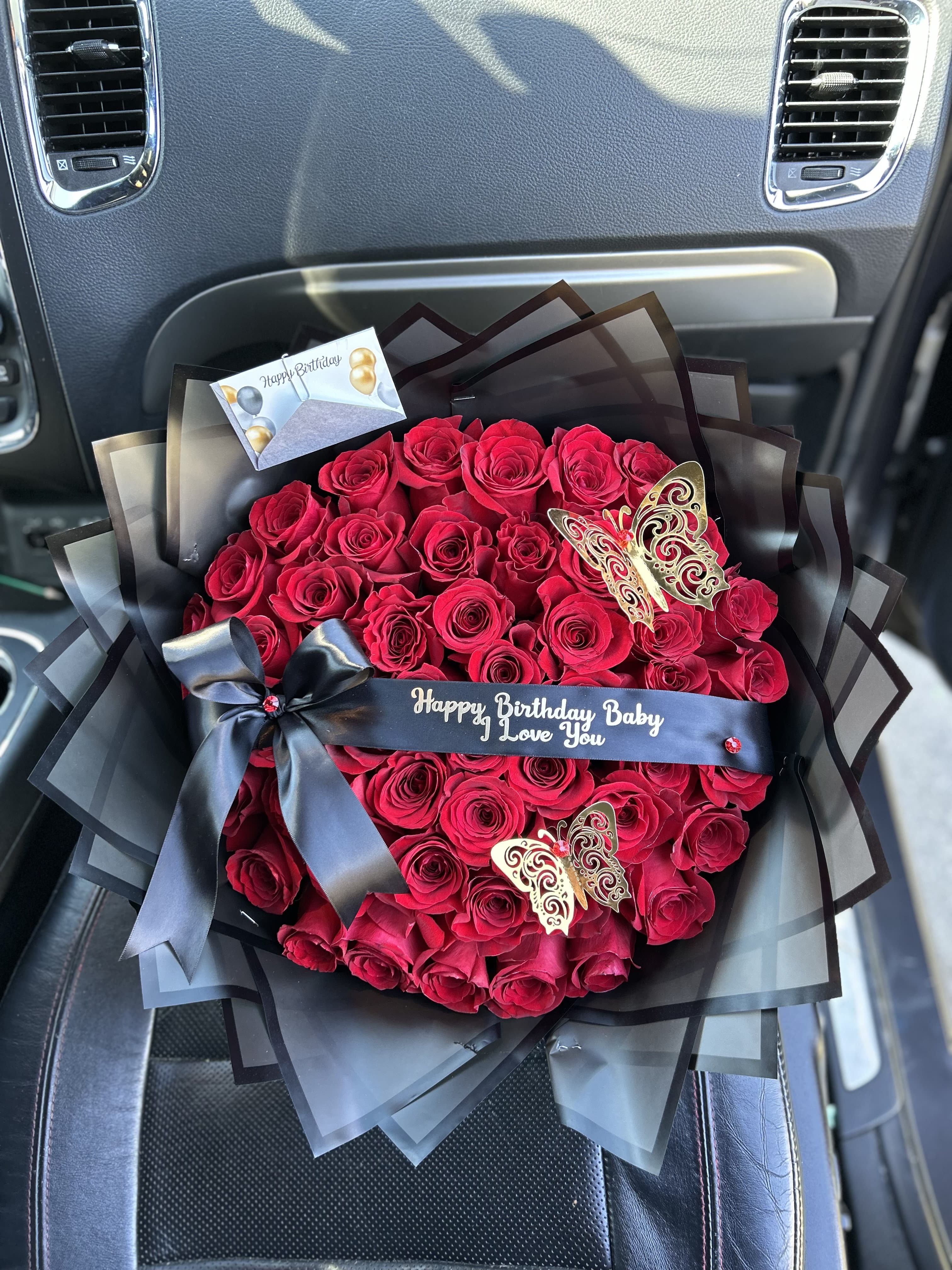 50 Red Roses w/black paper 50 Red Roses w/black paper - Complete with a personalized message and butterflies