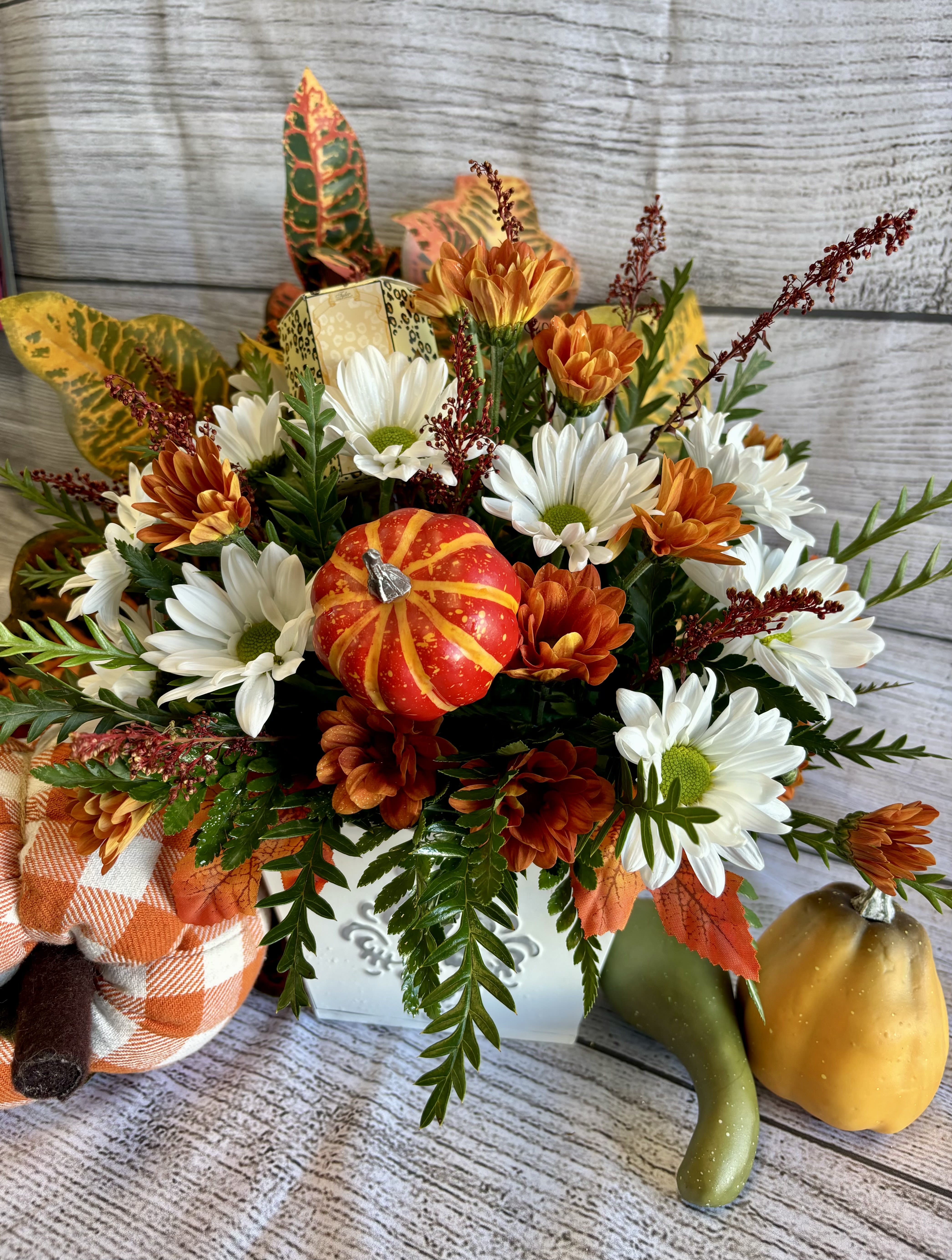 Autumn French Market Autumn French Market - Our best selling French Market is now available in a fall theme! A rustic tin container holds blooms you might find while strolling along the street side of a french market. Votive candle included.