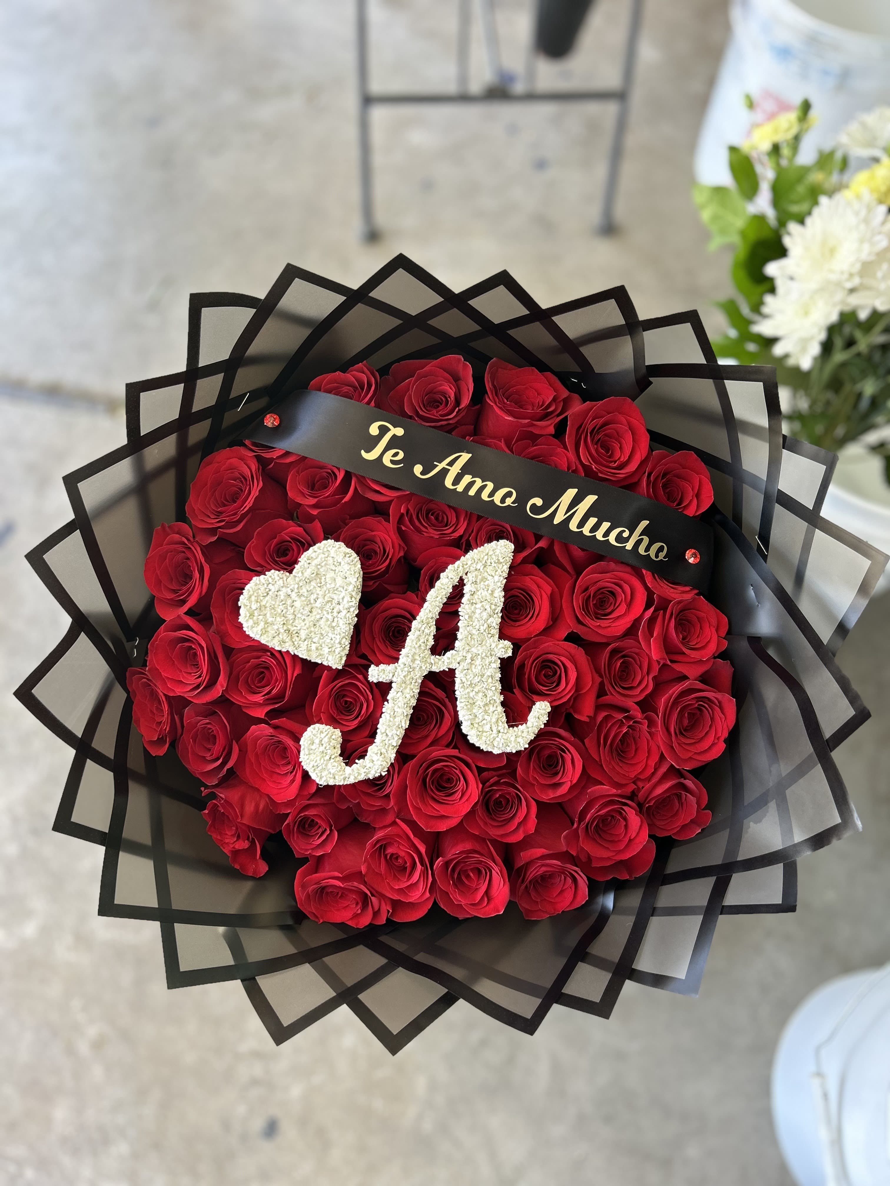 50 red roses with letter - 50 red roses, complete with black paper, a ribbon and 1 letter made of baby’s breath 