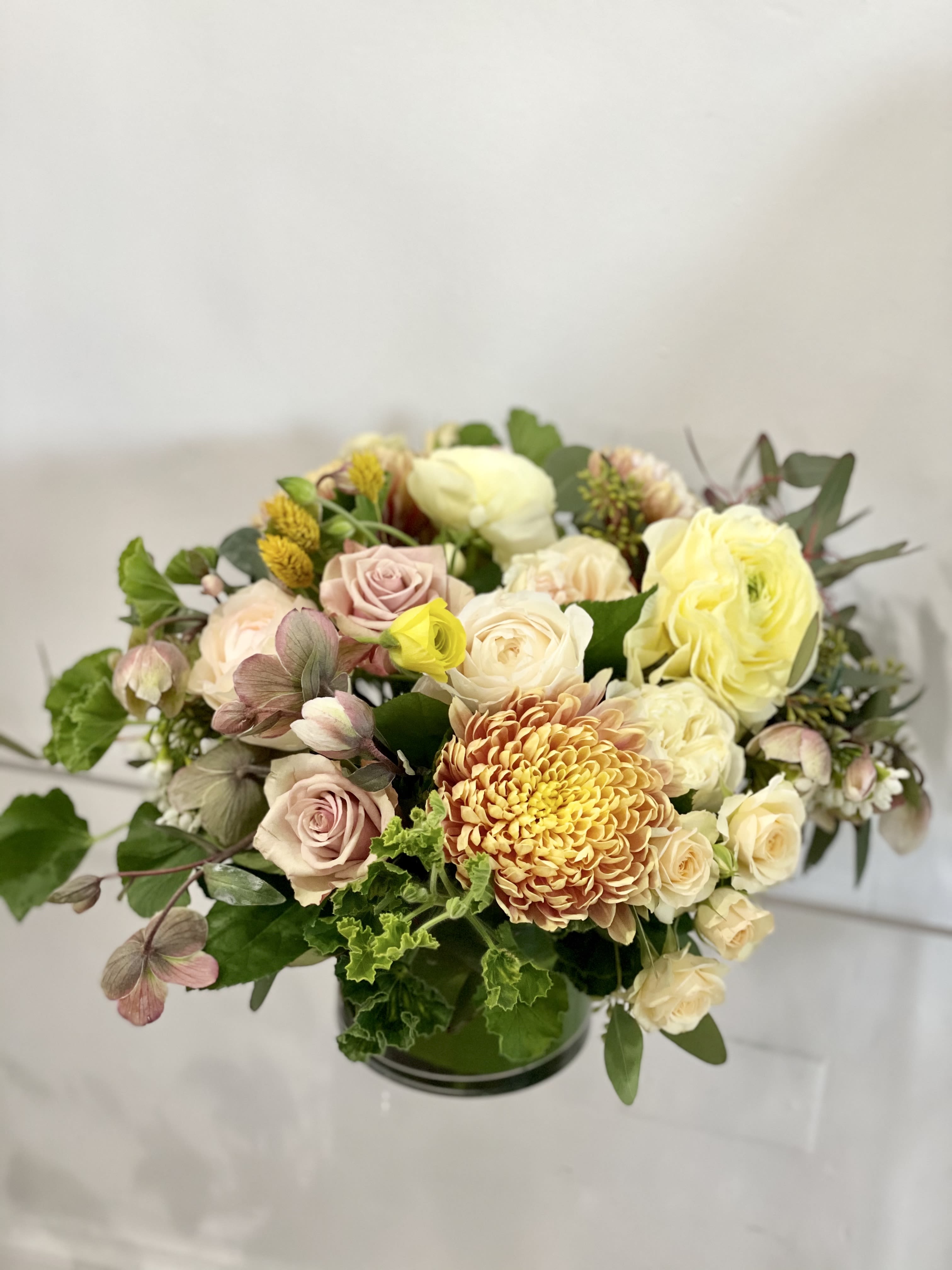 Mellow yellow - Mellow yellow is features a soft feminine palette of butter yellow, mauve, pinks, and greens. This is a special arrangement, designers choice premium blooms for a flower lover. An amazing centerpiece to admire on a dining table or a coffee table. This is a stunner! 