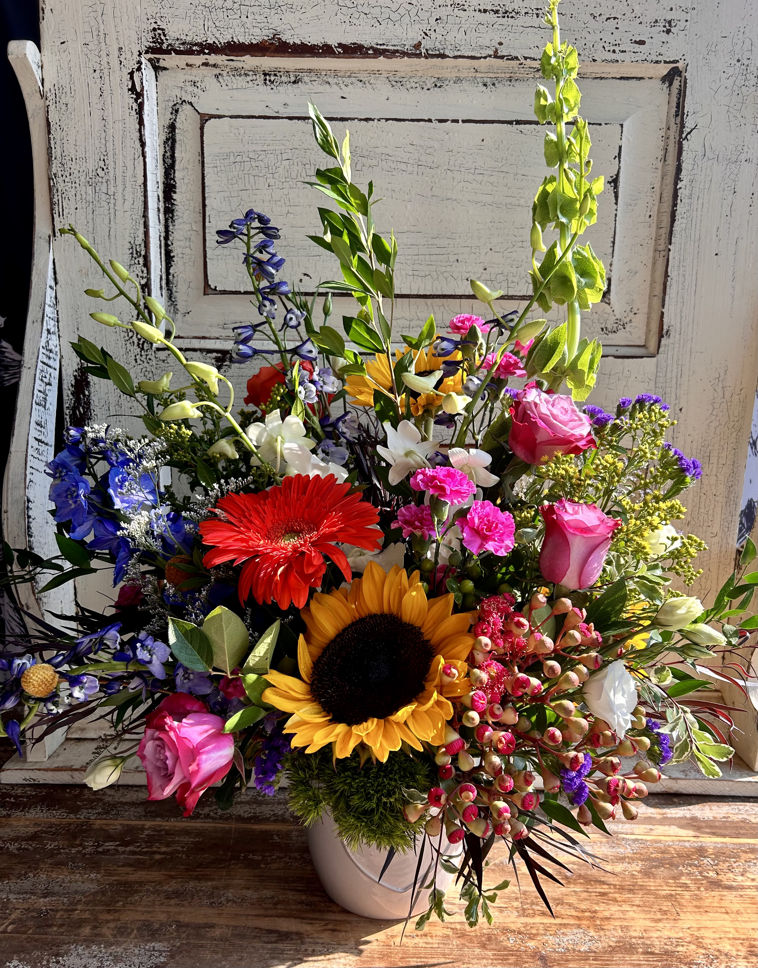 Vibrant - When you are looking for the wow factor! A ceramic or glass vessel is designed with the most unique and vibrant blooms of the season. Exact flower varieties will vary based on our cooler inventory but a custom arrangement of colorful and unique blooms will be sent from you.