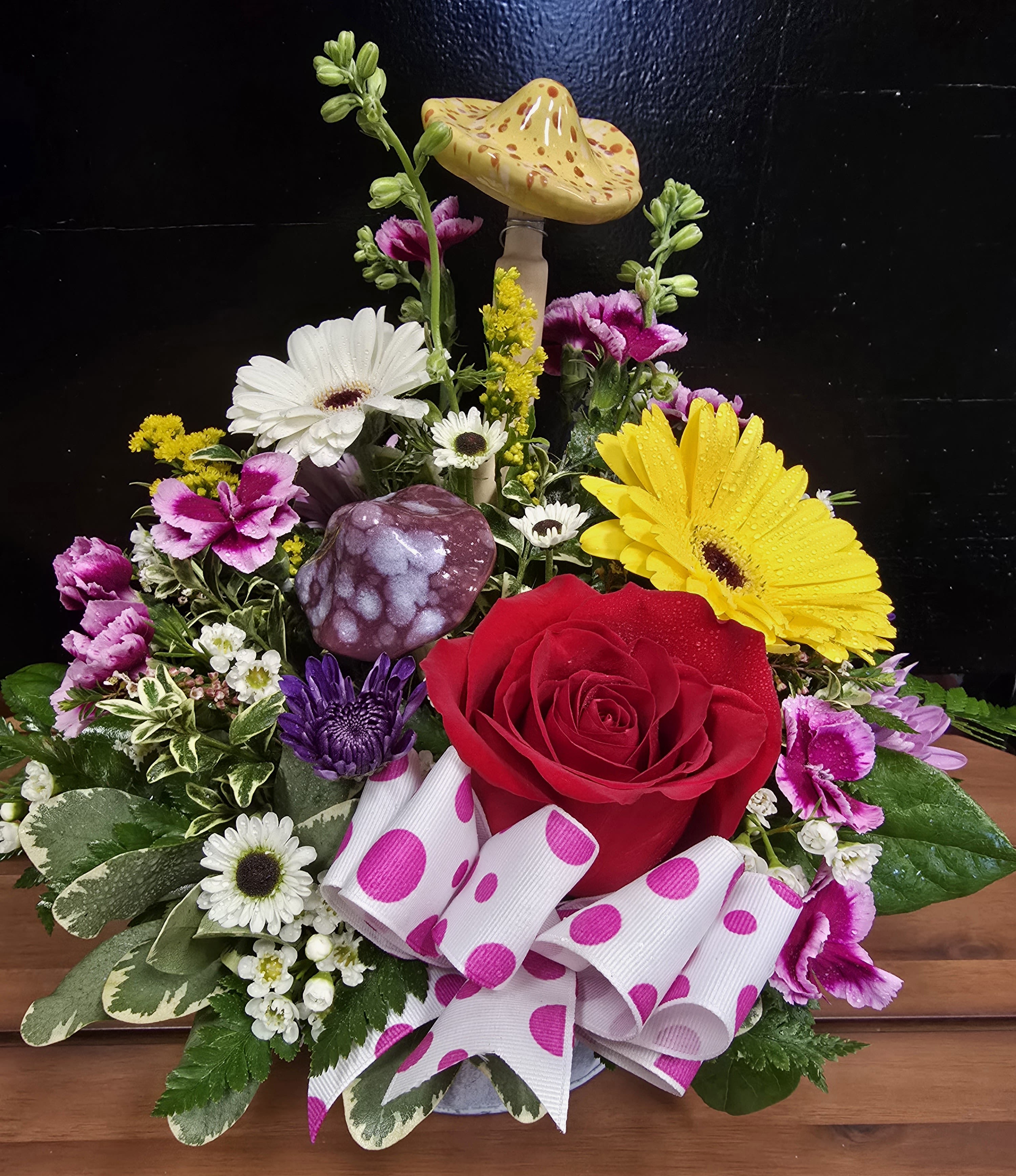 Alice in Wonderland - This bouquet takes on the wonderful look of the actual movie that someone would love to get for any occasion.  Please keep in mind each arrangement designed might have some color changes based on current supply of flowers.