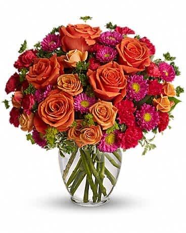 How Sweet It Is How Sweet It Is - How sweet it will be when this dazzling arrangement arrives at someone's door. Very vibrant. Very vivacious. And very, very pretty. Light orange roses, orange spray roses, and matsumoto asters, hot pink miniature carnations and more are delivered in a lovely glass vase. Be sweet and send this one today!