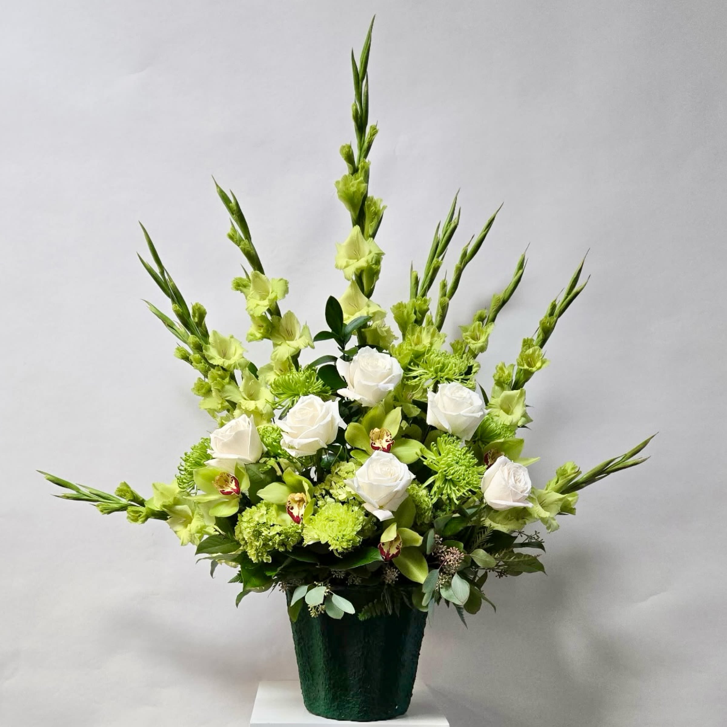 Evergreen Peace Arrangement - The Arrangement Includes Green Gladiolas, Green Fuji Mum, White Roses, Green Cymbidium Blooms and Mini Green Hydrangea. Or as Similar as Possible. 
