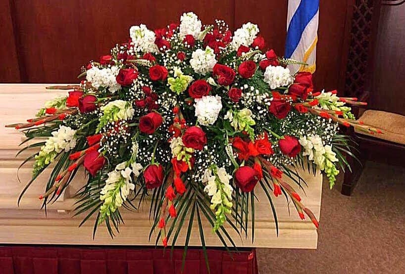 Loving Romance Casket Spray Loving Romance Casket Spray - This elegant red and white casket spray is a timeless funeral flower arrangement, symbolizing love, respect, and remembrance. Featuring classic red roses, snapdragons, stock, baby’s breath, and other traditional blooms, this design is beautifully handcrafted as a heartfelt tribute. Traditionally ordered by the deceased’s immediate family, casket sprays require at least 24 hours’ notice for preparation and delivery.