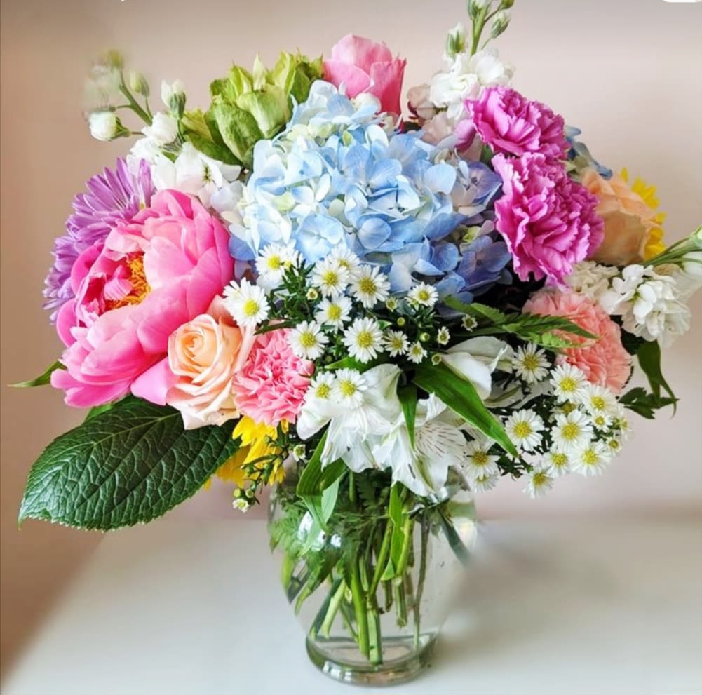 Grandmother's Garden by Pretty in Petals  - A delightful blend of classic blooms and charming greenery, reminiscent of a sun-kissed, old-fashioned garden. This arrangement features a mix of textures and colors, bringing the warmth and beauty of a grandmother's garden right to your doorstep.